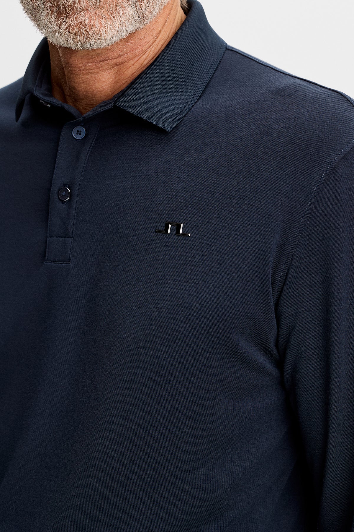 Dark navy long-sleeve polo with fold-over collar and small chest logo