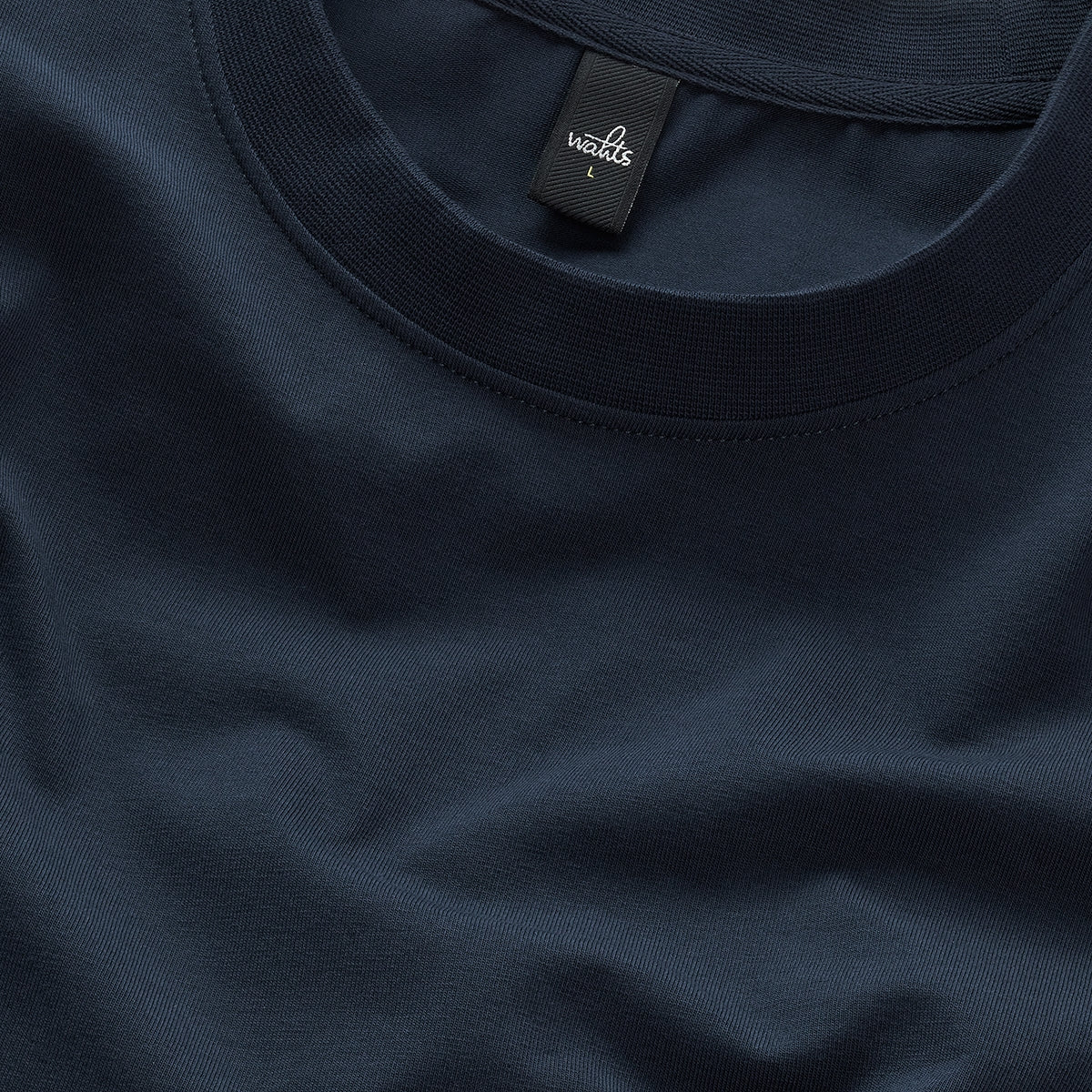WAHTS deep navy T-shirt collar close-up with ribbed crew neckline label