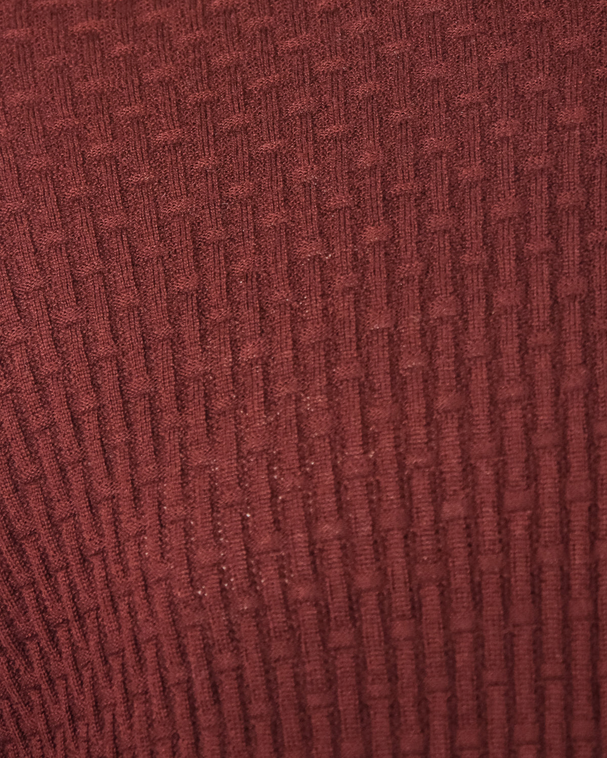Burgundy textured knit fabric with allover square weave pattern