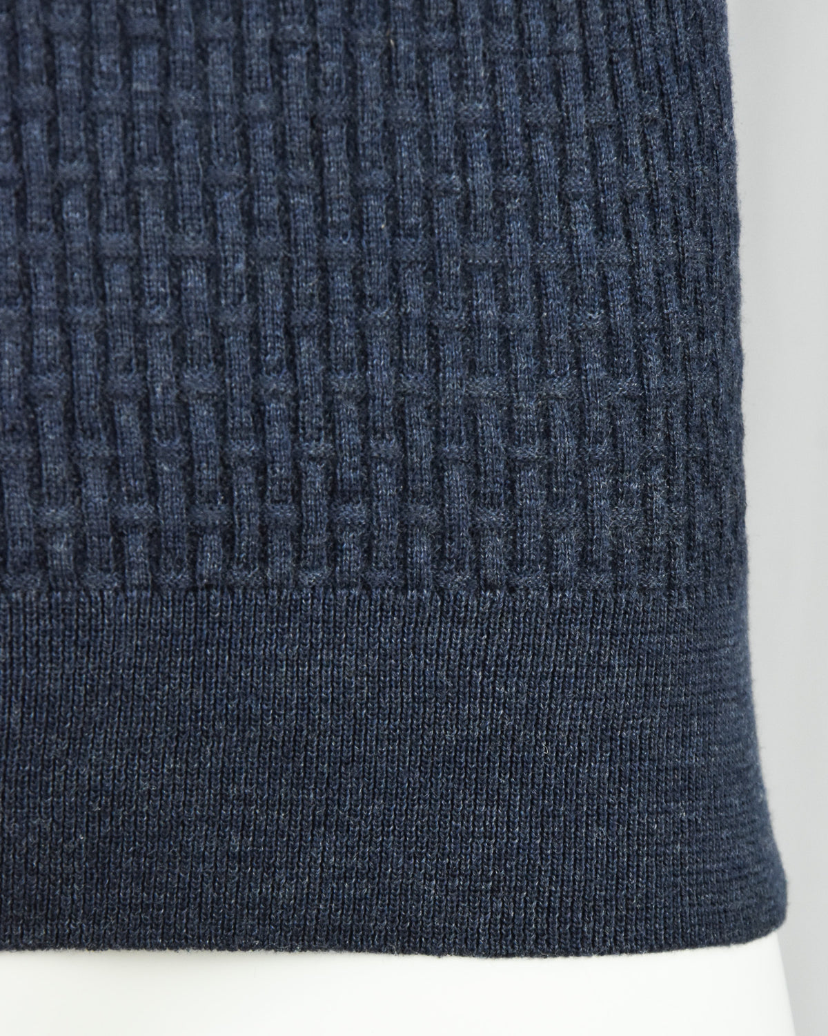 Blue ribbed knit hem cuff detail on long-sleeve polo