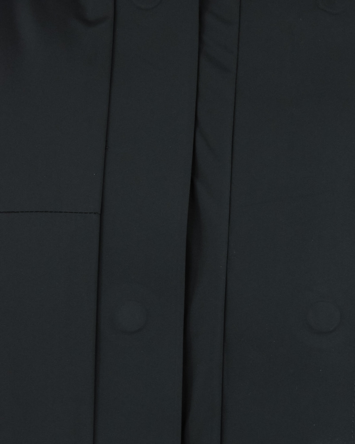 Black parka front panel close-up with vertical seams and center placket