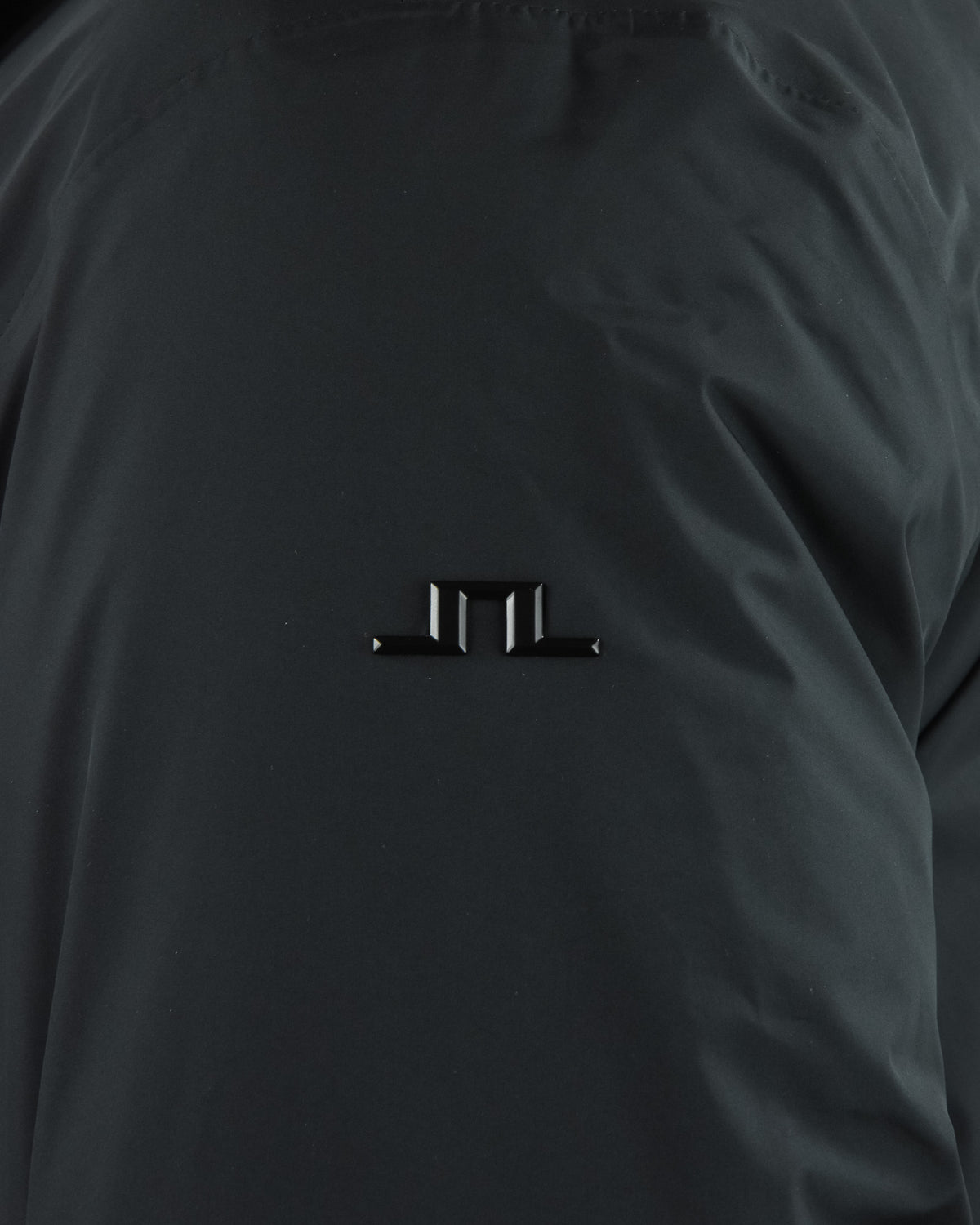 Black parka chest logo detail on matte outer fabric
