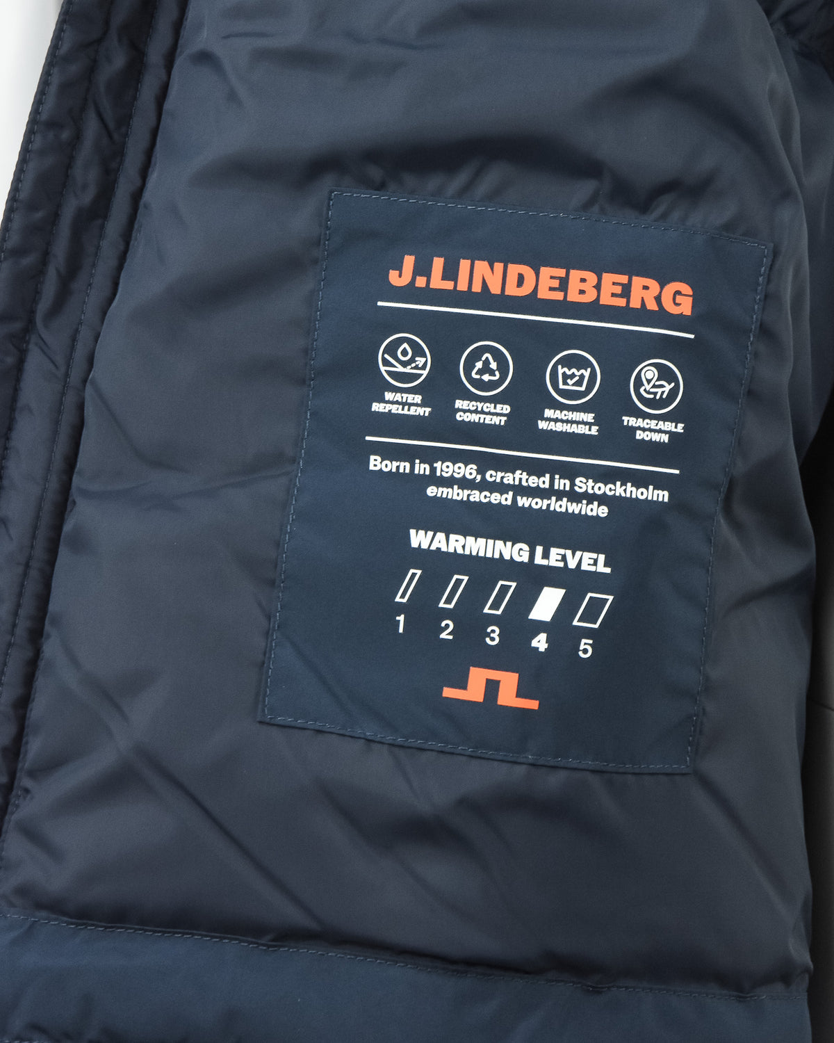 Navy down jacket interior brand patch with warmth level icons