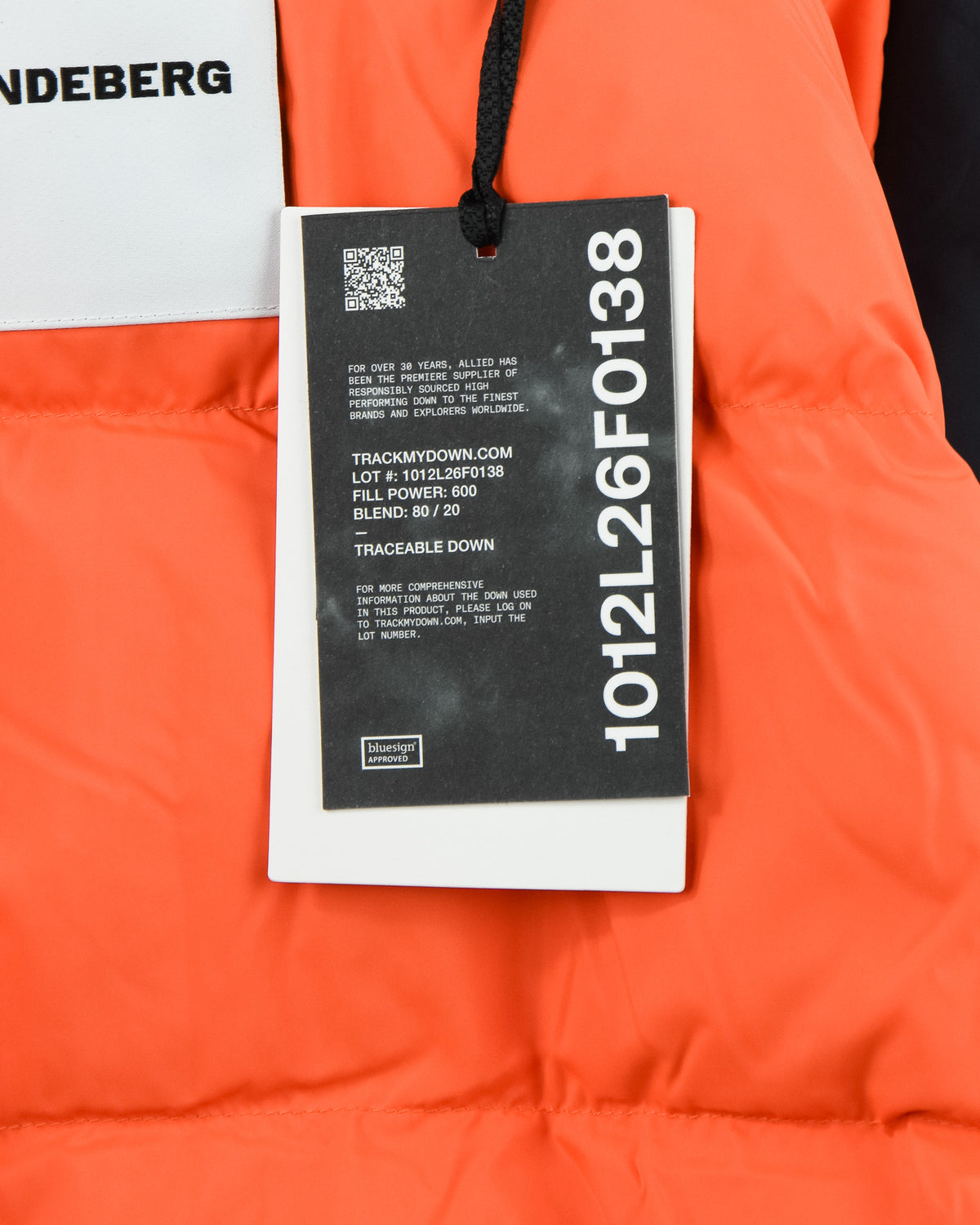 Orange interior lining with black traceability hangtag and barcode