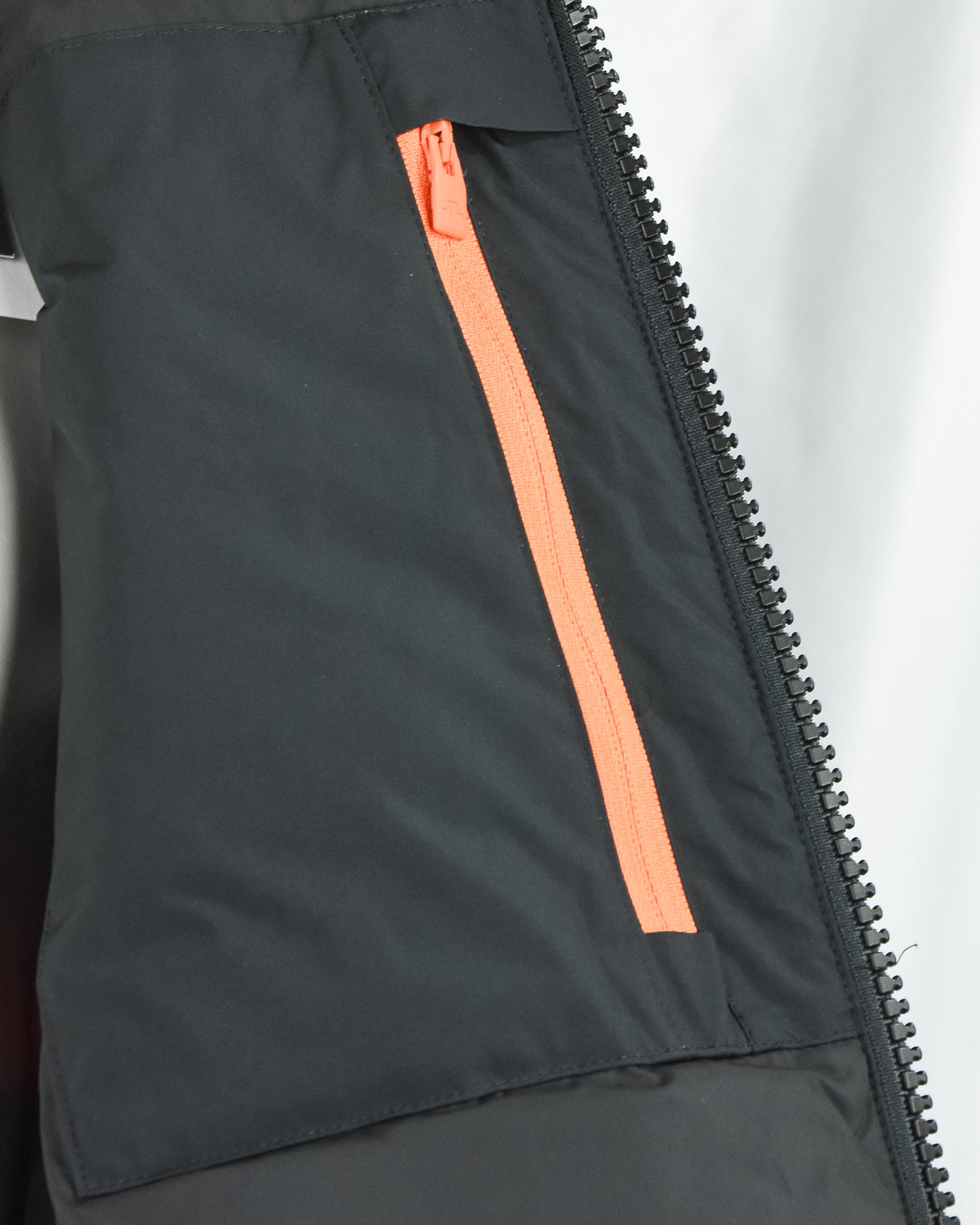 Orange inner zipper tape on black down jacket front