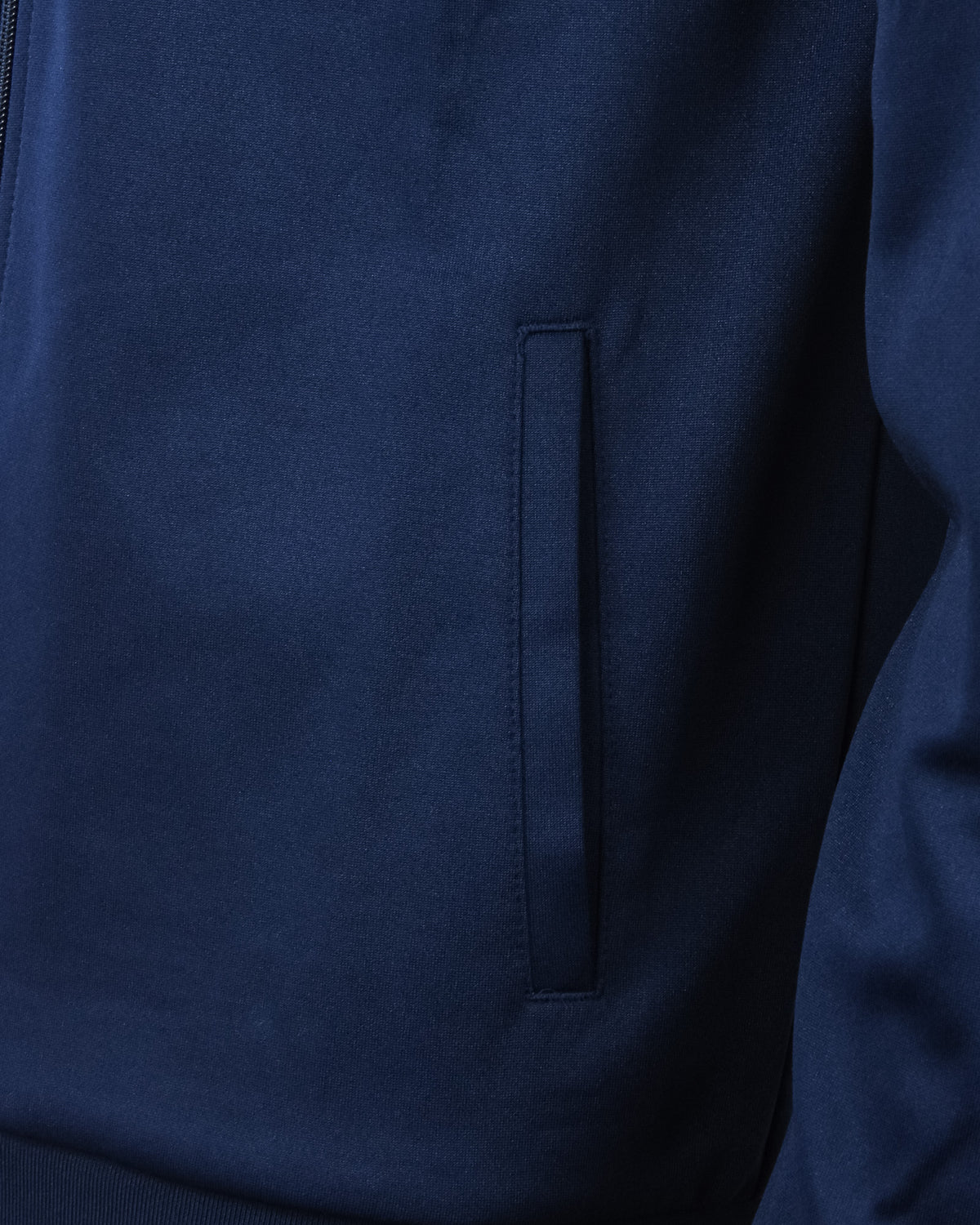 Navy track top jacket with vertical welt pocket detail and zip seam