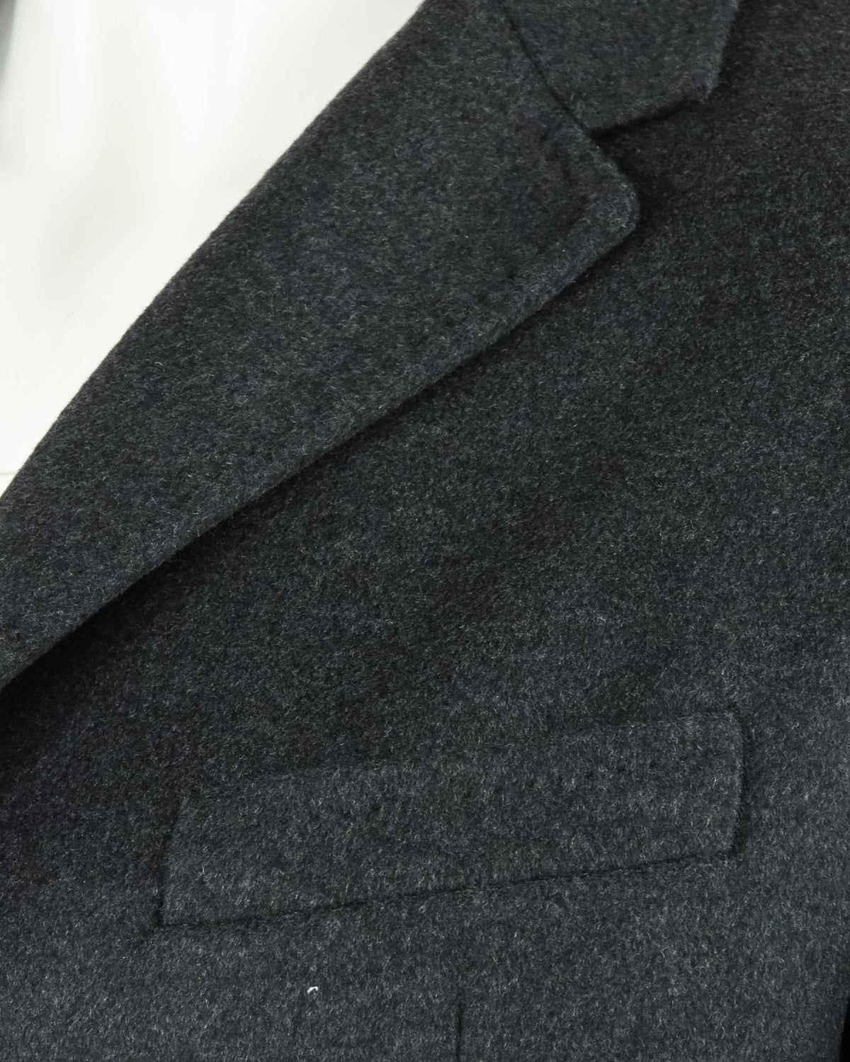 Charcoal grey overcoat lapel and welt chest pocket detail