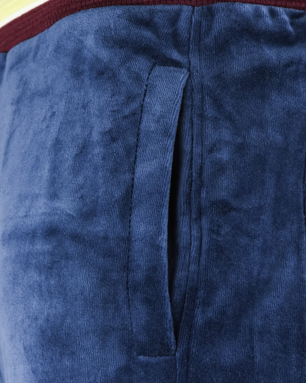 Velour track pants waistband and drawstring detail on blue fabric