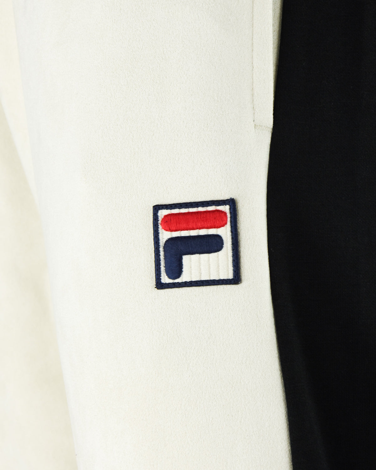 FILA logo patch on cream track pants with black side panel