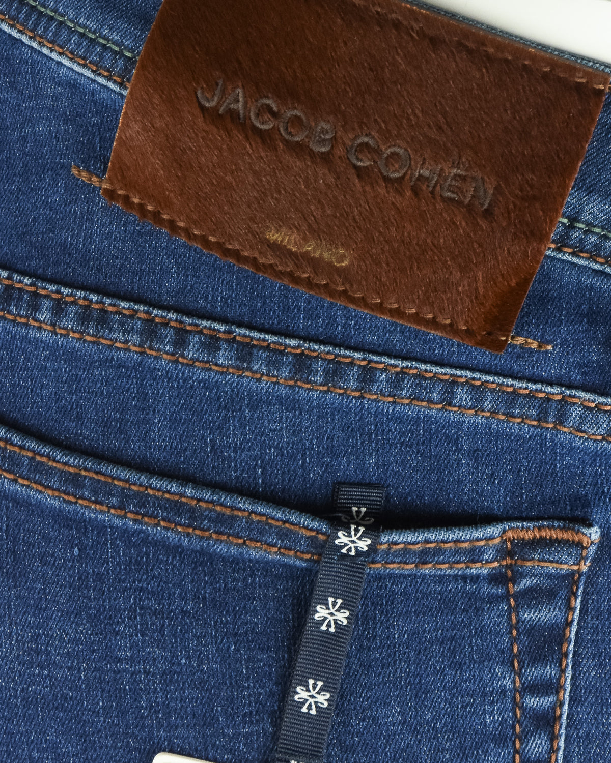 Brown leather brand label on blue denim pocket