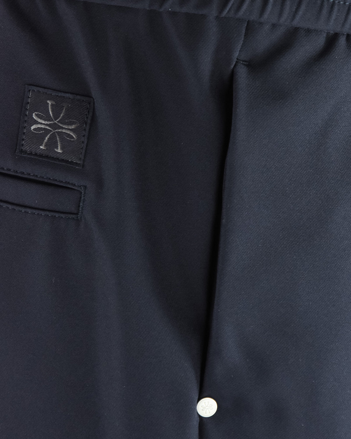 Navy tech pants with logo patch and front pocket seam