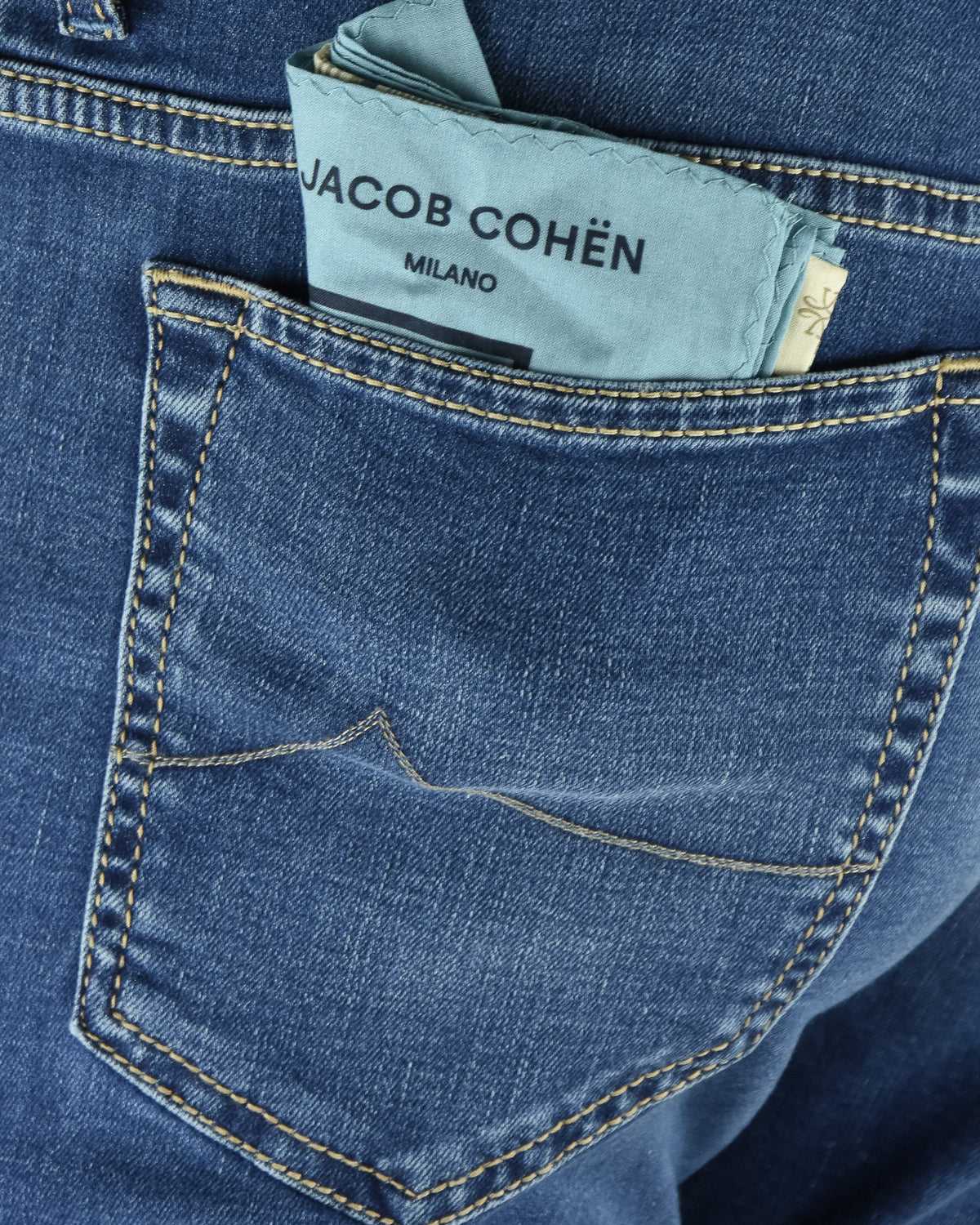Blue denim front pocket with contrast yellow stitching and logo label