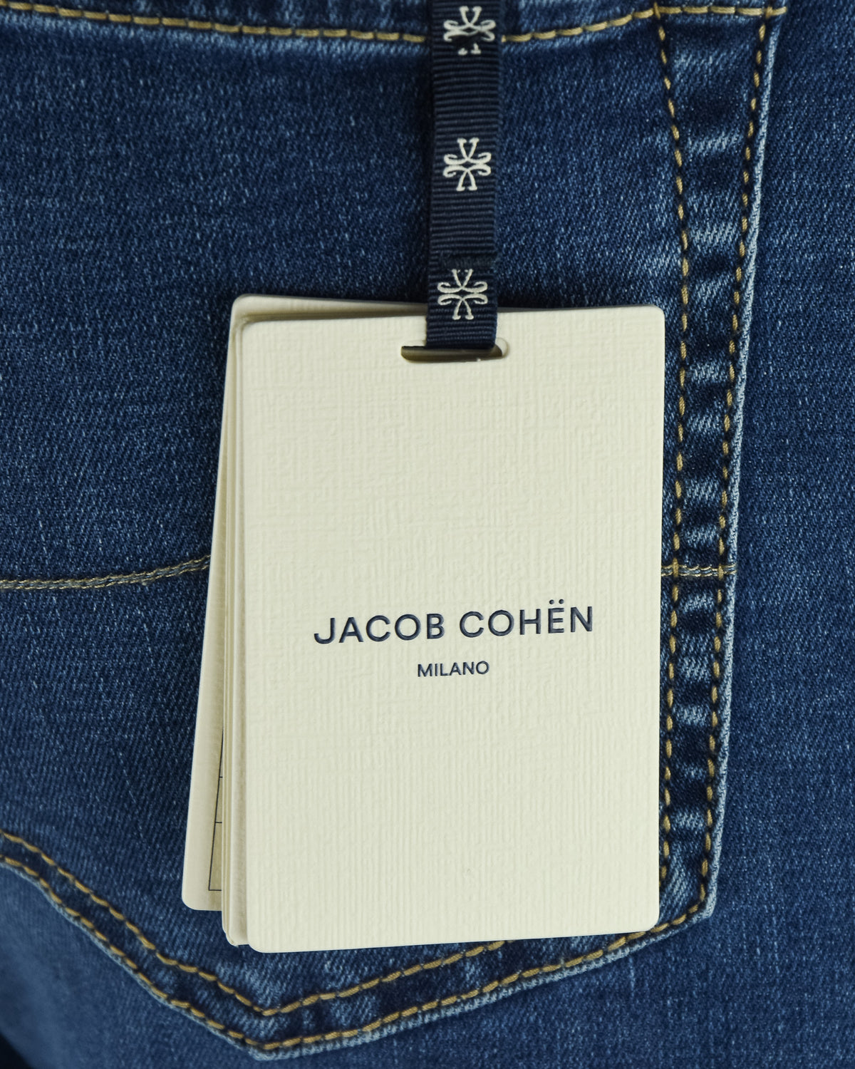 Blue denim jeans with hanging Jacob Cohen Milano care tag