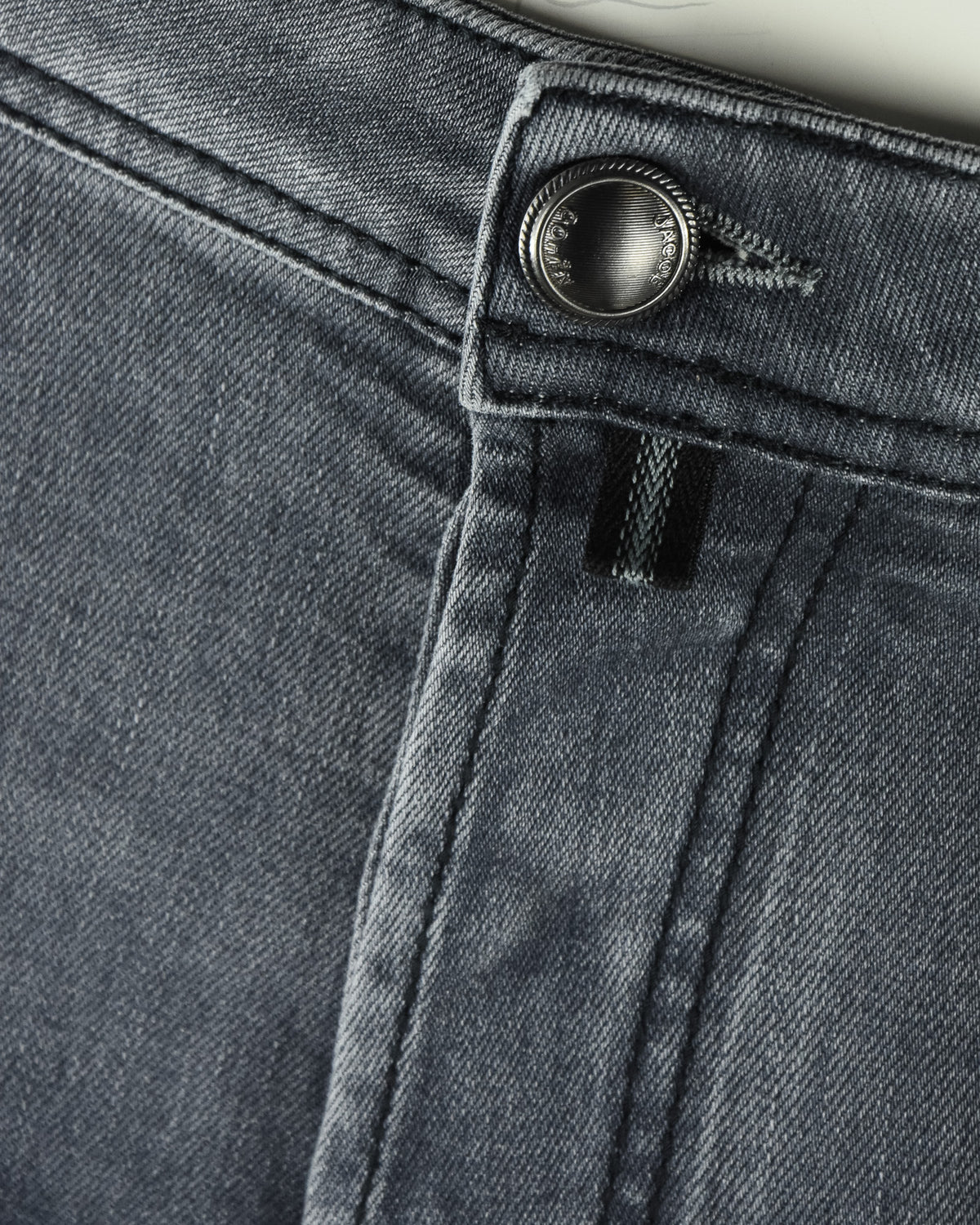 Grey denim button fly with metal button and inner zipper placket