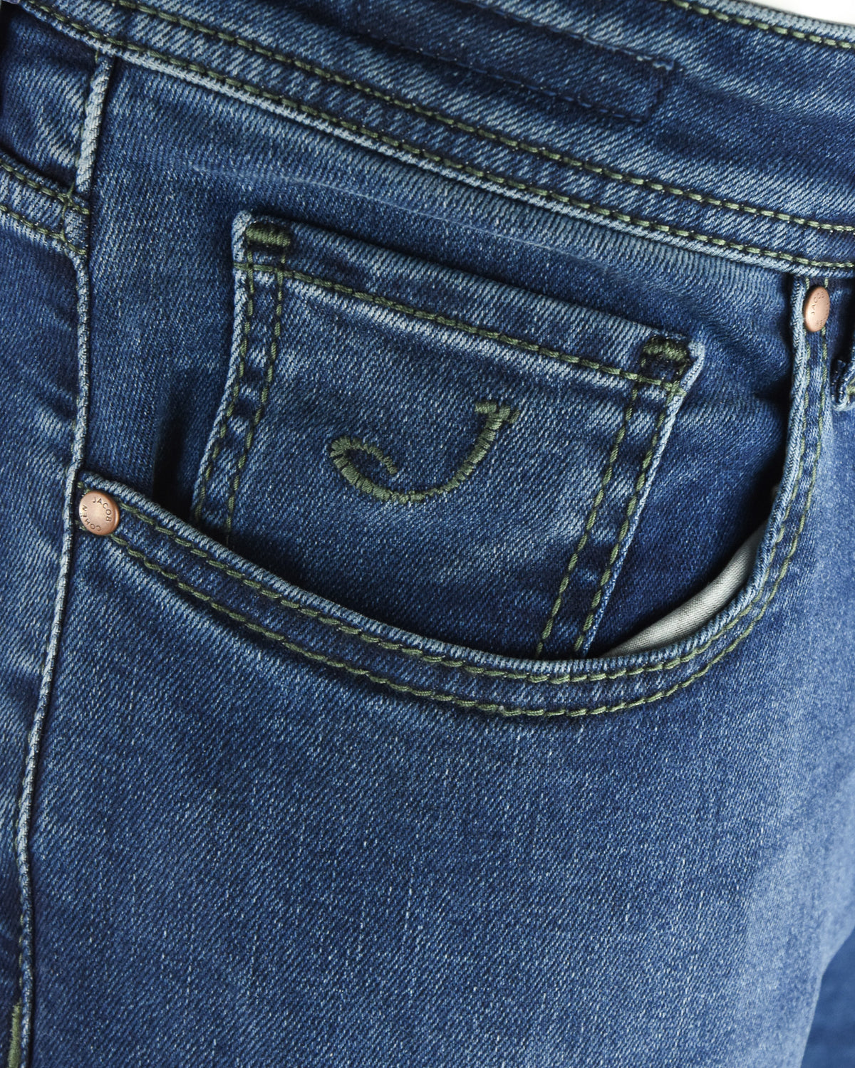 Back denim pocket with green contrast stitching and small embroidered logo detail.
