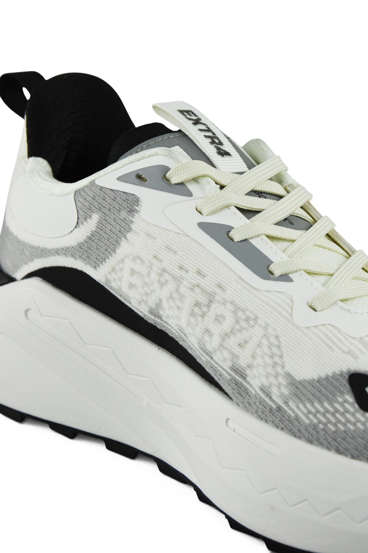 Angled view of white and gray waterproof running shoes with light green lace system