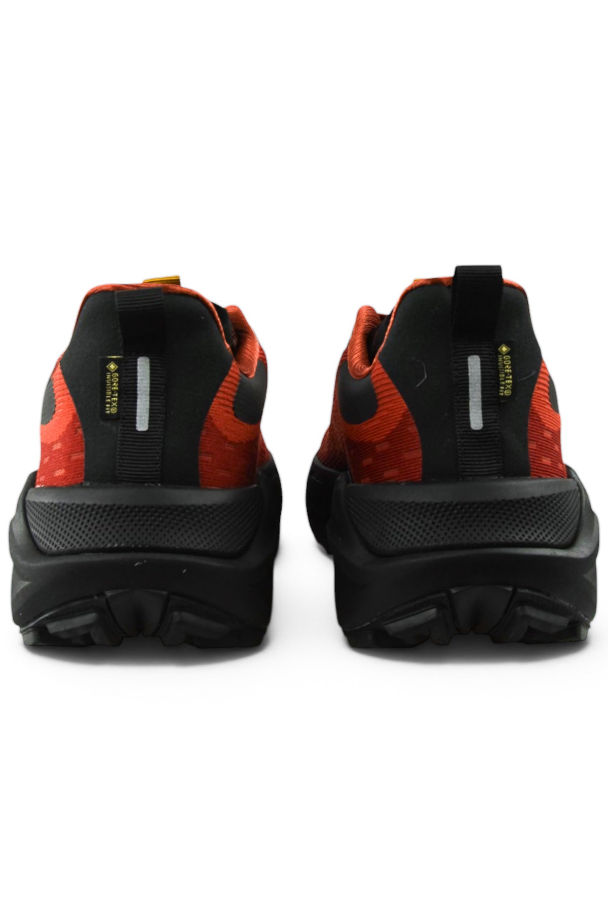 Pair of waterproof running shoes in rust orange and black, rear view with heel tab