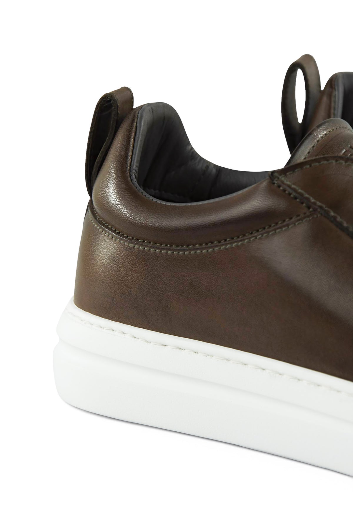 Brown leather low-top trainer heel with padded collar and white rubber sole