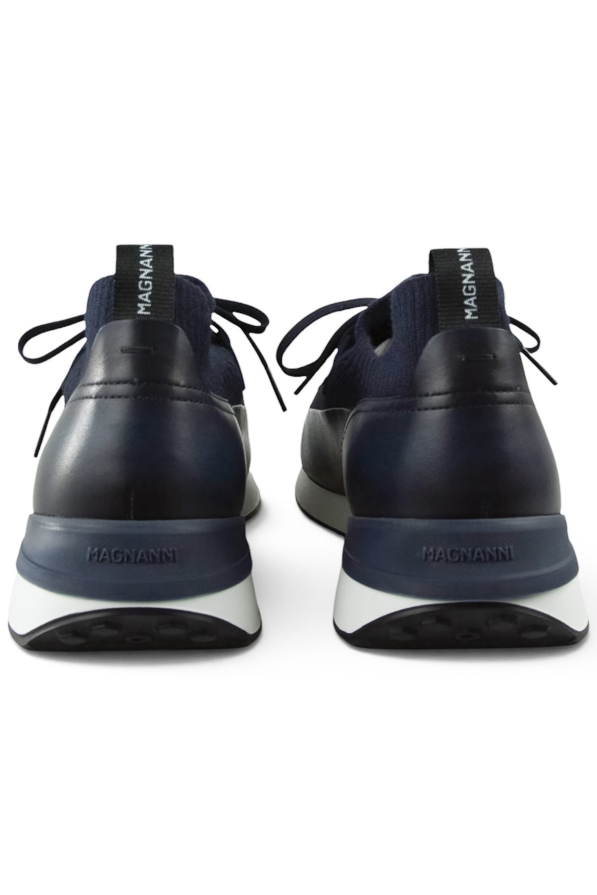 Back view of dark blue trainers with heel tabs and "MAGNANNI" branding on leather