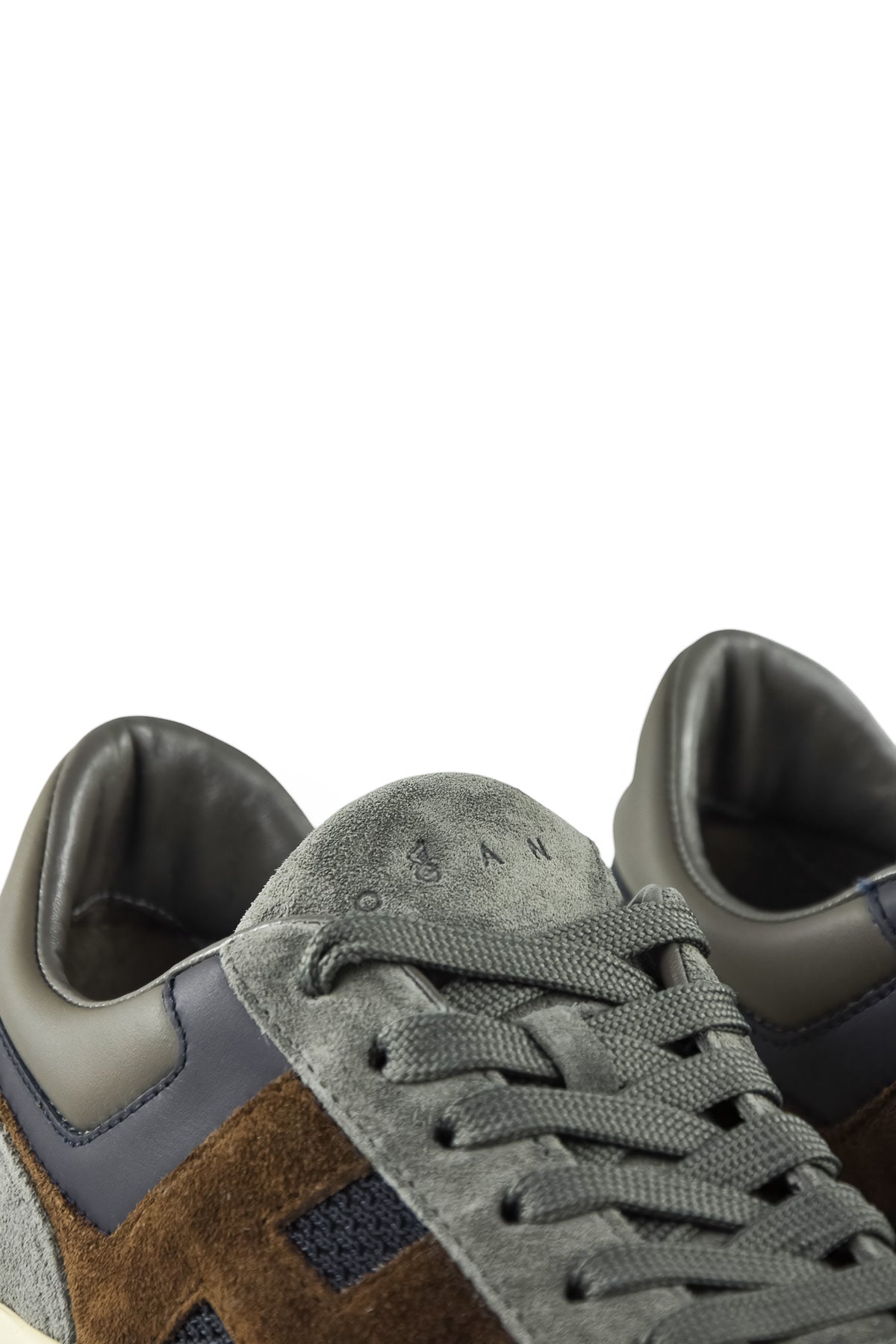 Hogan runner trainer close-up of lace area with grey suede and blue overlay