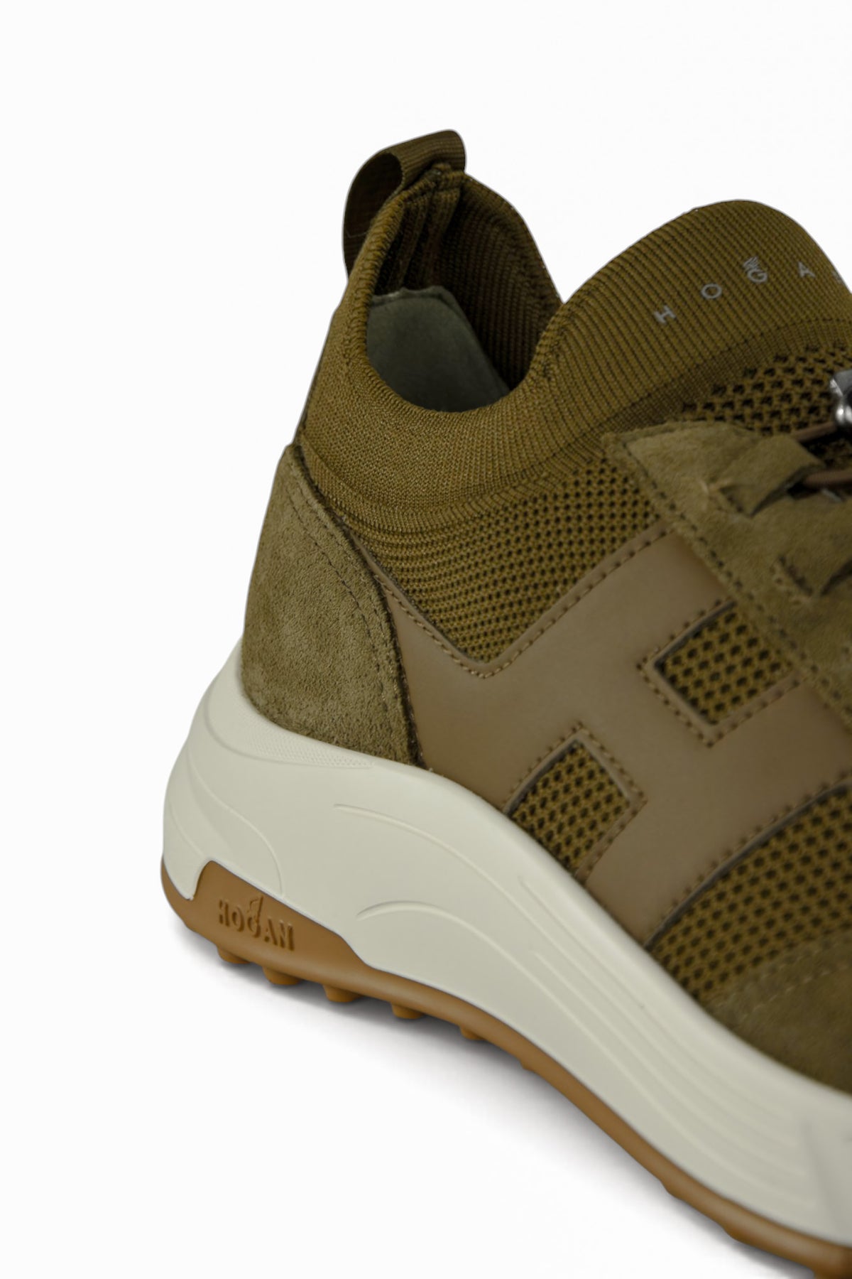 Khaki trainer heel and side panel with white midsole and tread edge