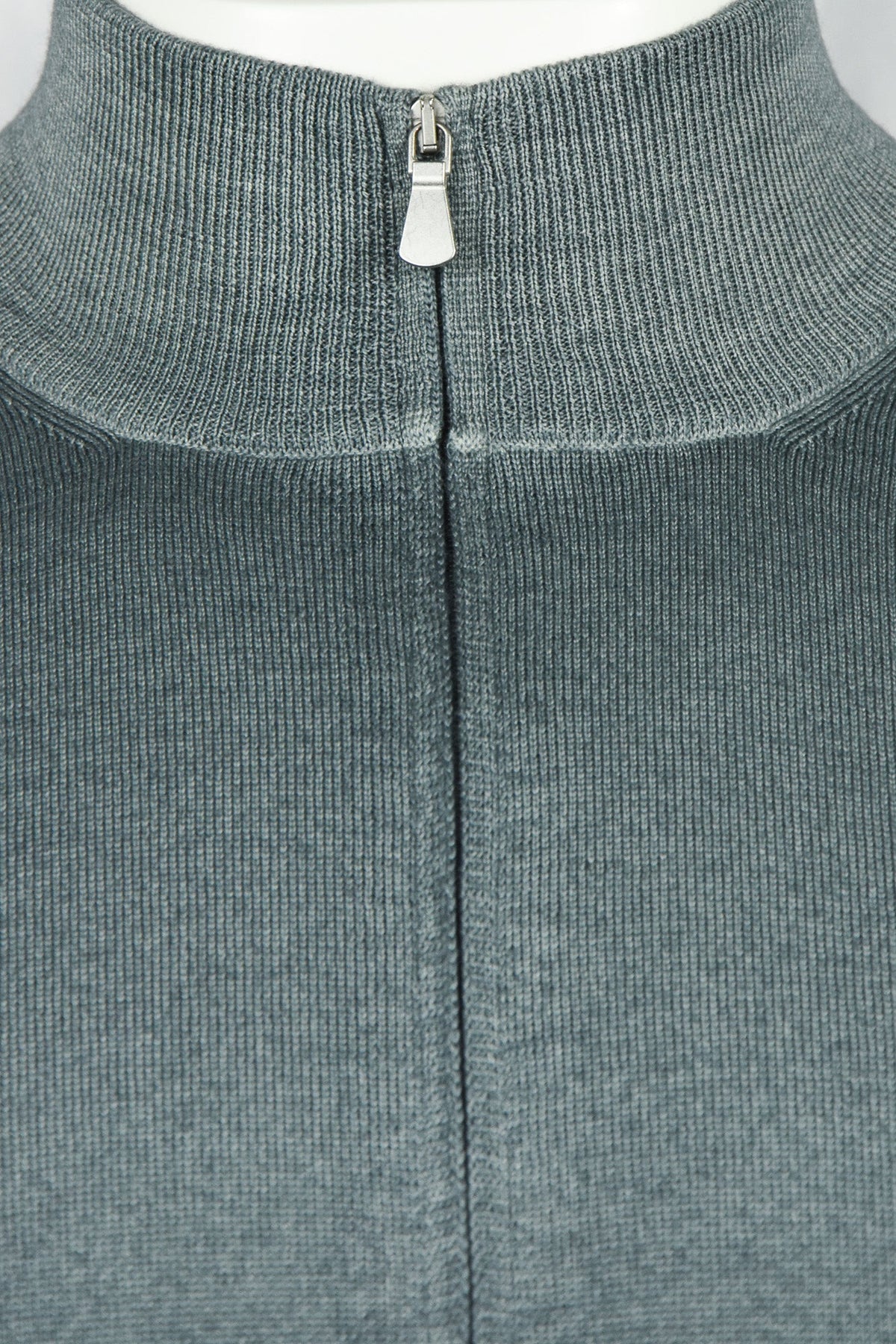 Petrol blue ribbed stand collar with metal zip pull on full-zip cardigan.