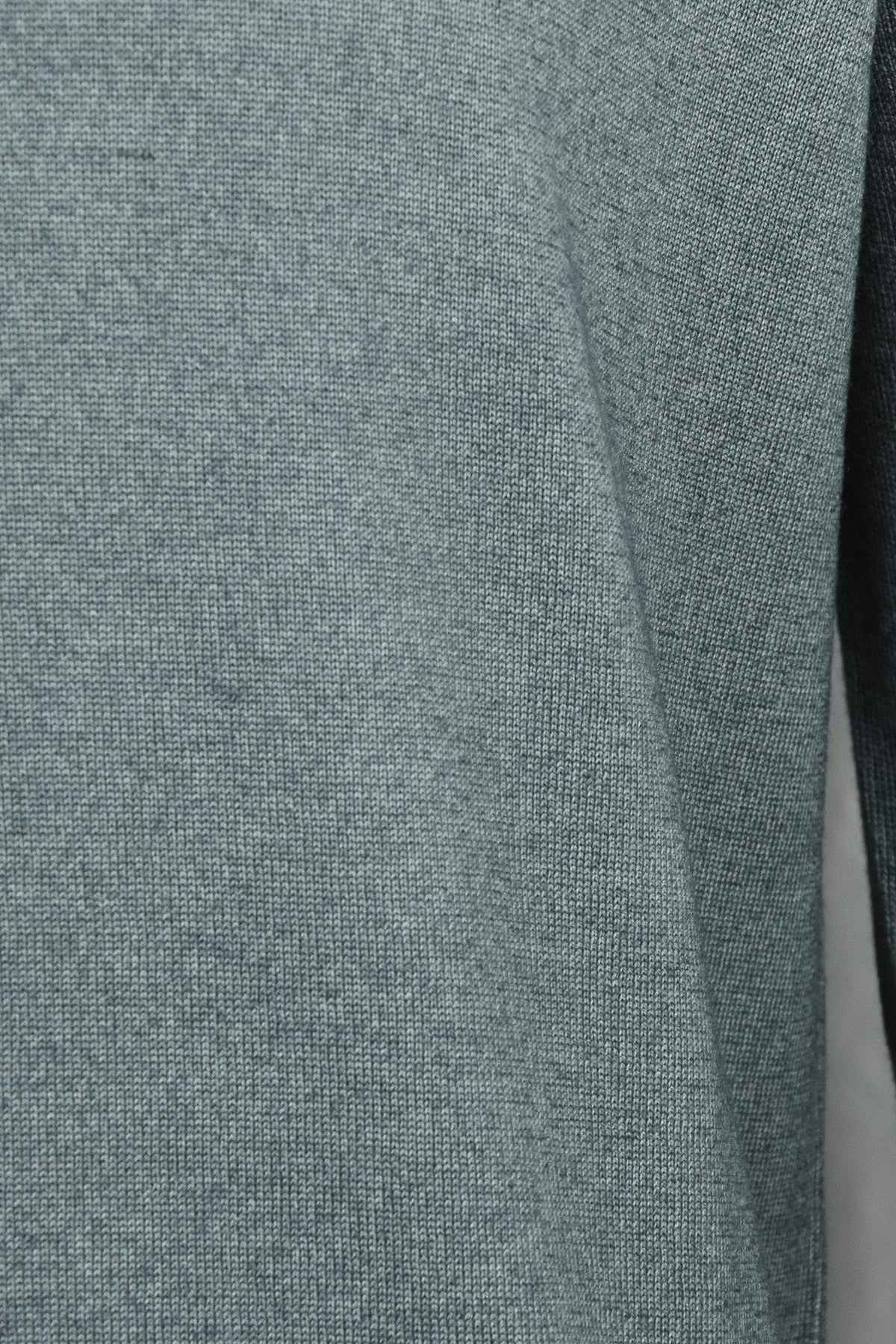 Petrol blue knit fabric cardigan panel with smooth, textured knit surface.