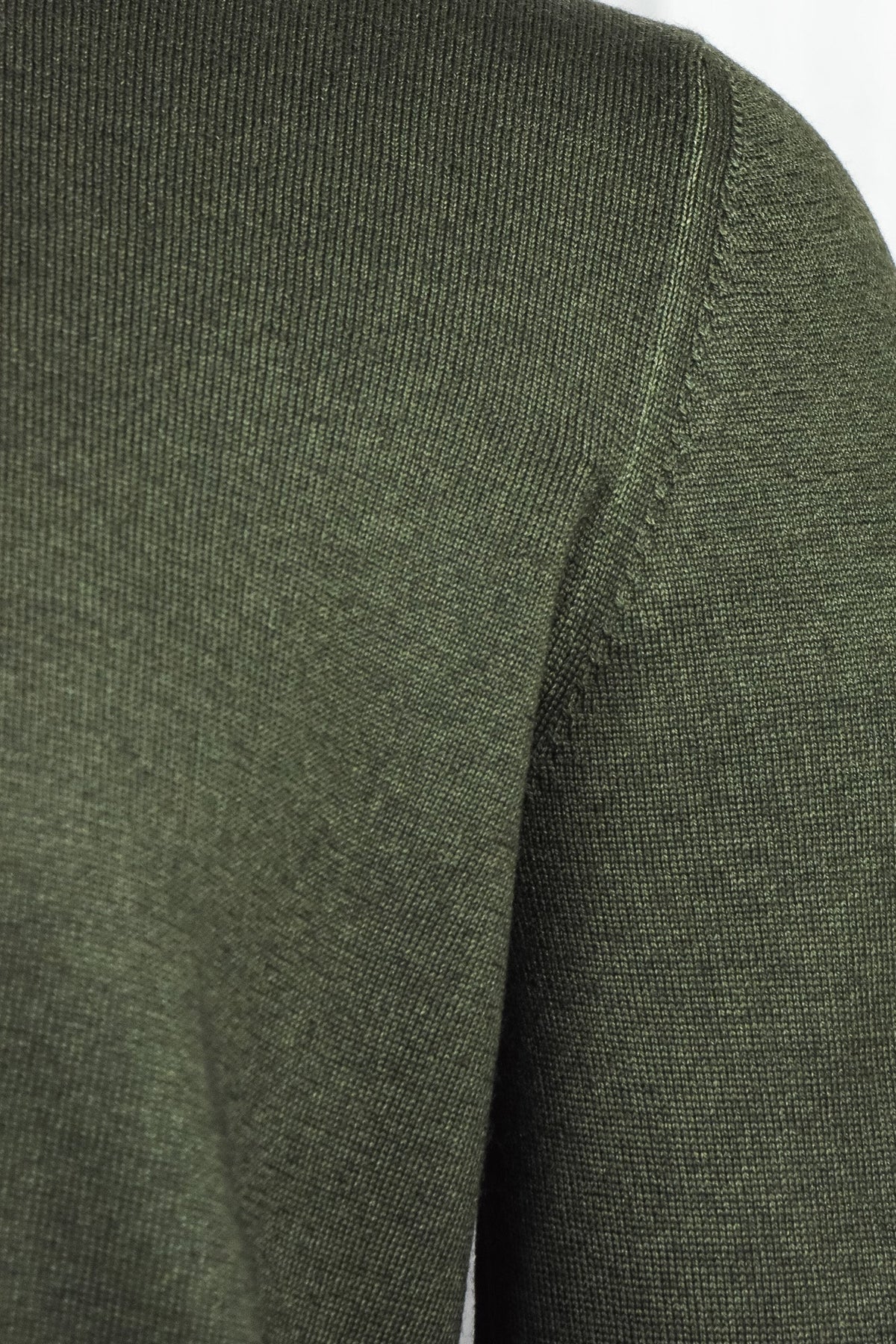 Bottle green cardigan sleeve and shoulder knit close-up