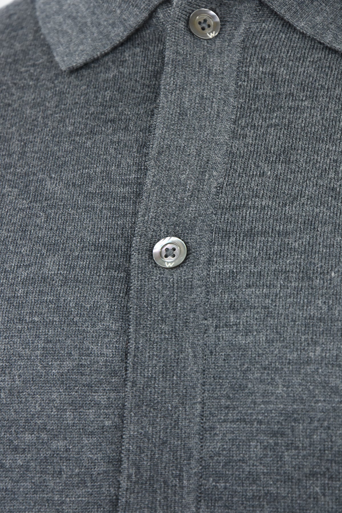 Close-up of the cardigan's gray melange knit and button placket
