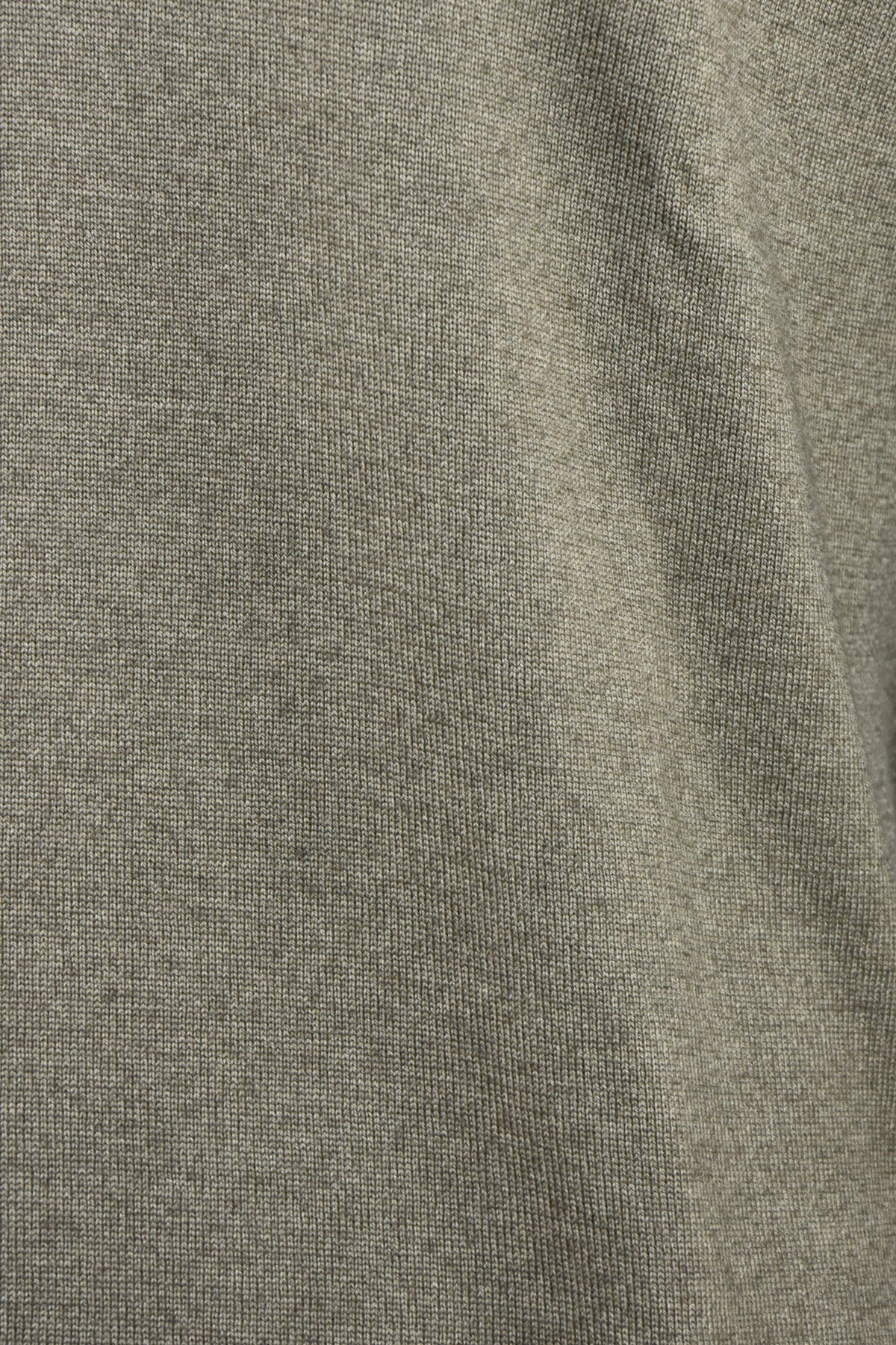Close-up of the jumper's fine garment-dyed knit texture in light brown