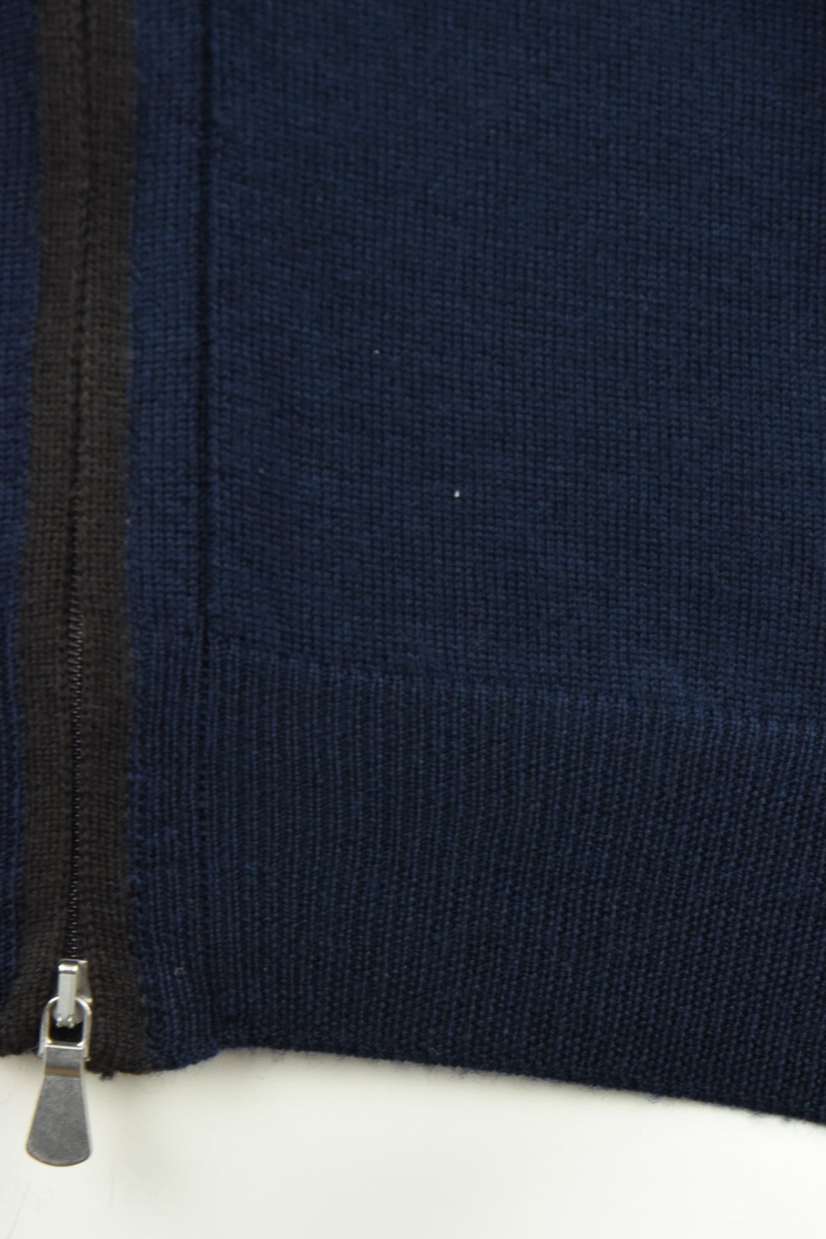 Navy cardigan hem detail with knit ribbing and zip end