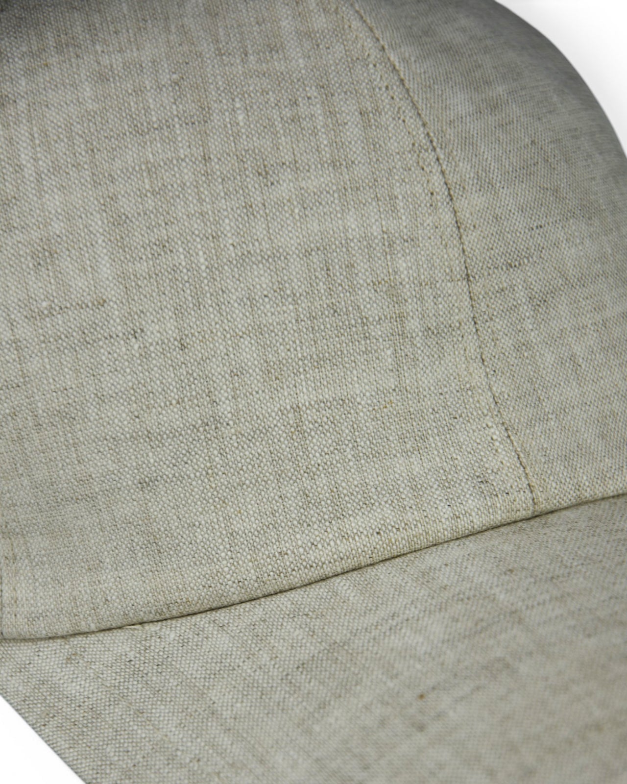 Stone grey linen baseball cap fabric close-up with curved brim stitching
