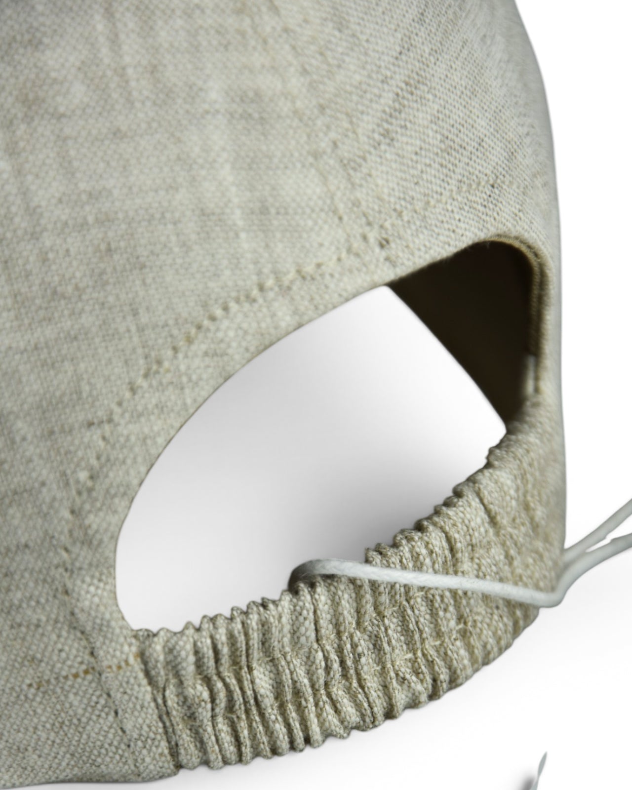 Stone grey linen baseball cap close-up of elastic opening at back hem