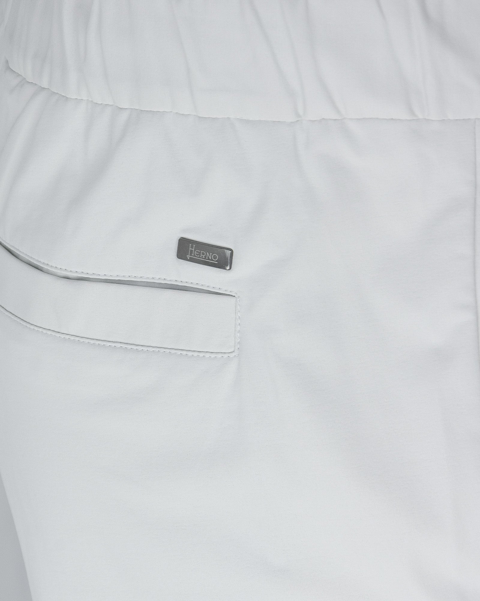 Off-white pants close-up: side pocket with welt seam and Herno label