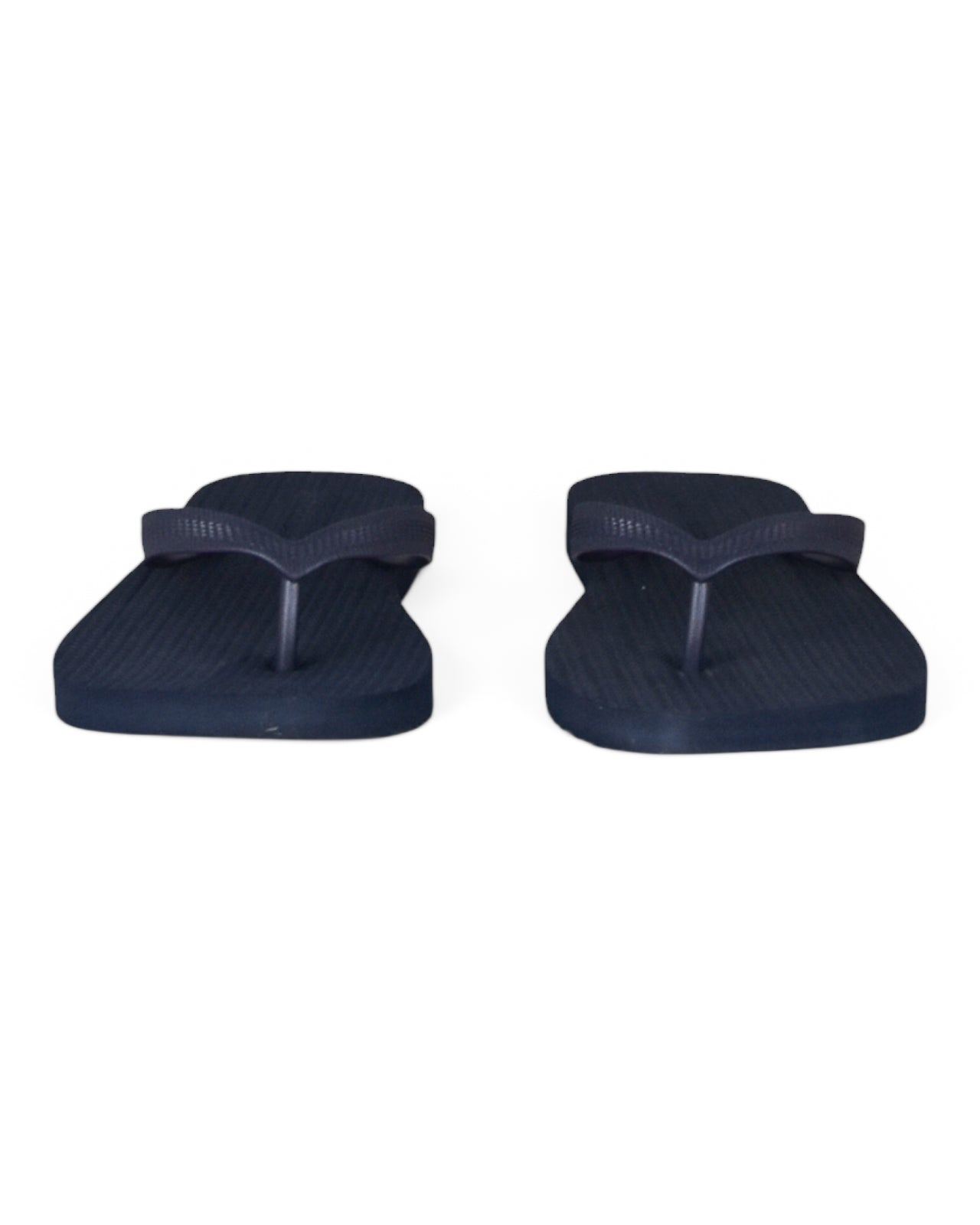 Set of dark blue flip-flops viewed from the footbed side
