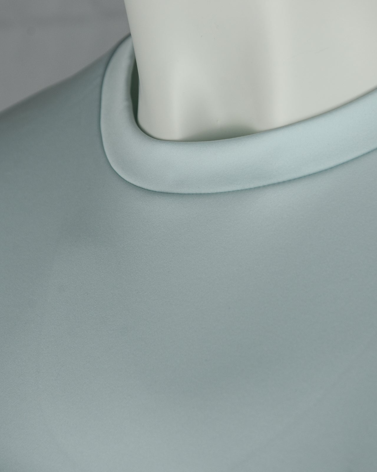 Crew neck trim close-up on light sky blue T-shirt