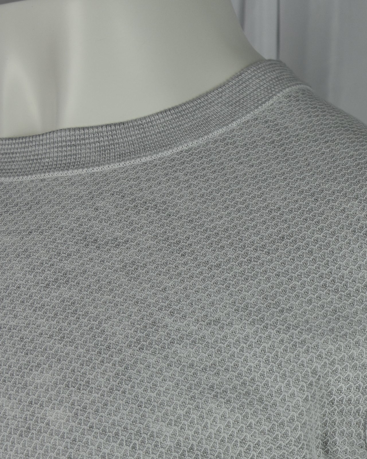 Grey textured knit T-shirt close-up of crew neck and fine waffle texture