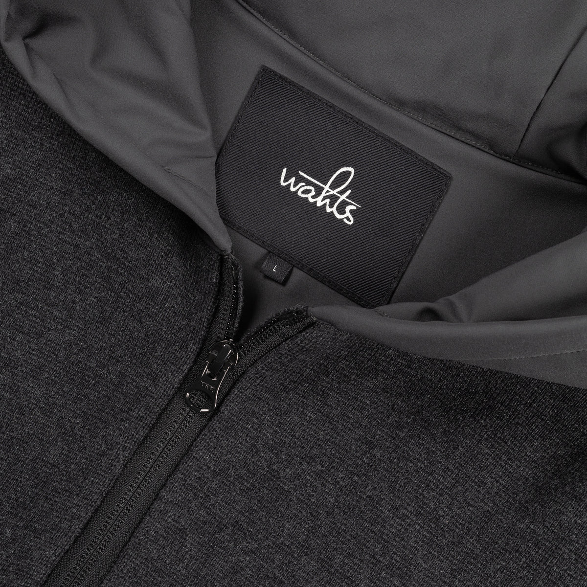 WAHTS logo label and front zipper detail on dark hoodie