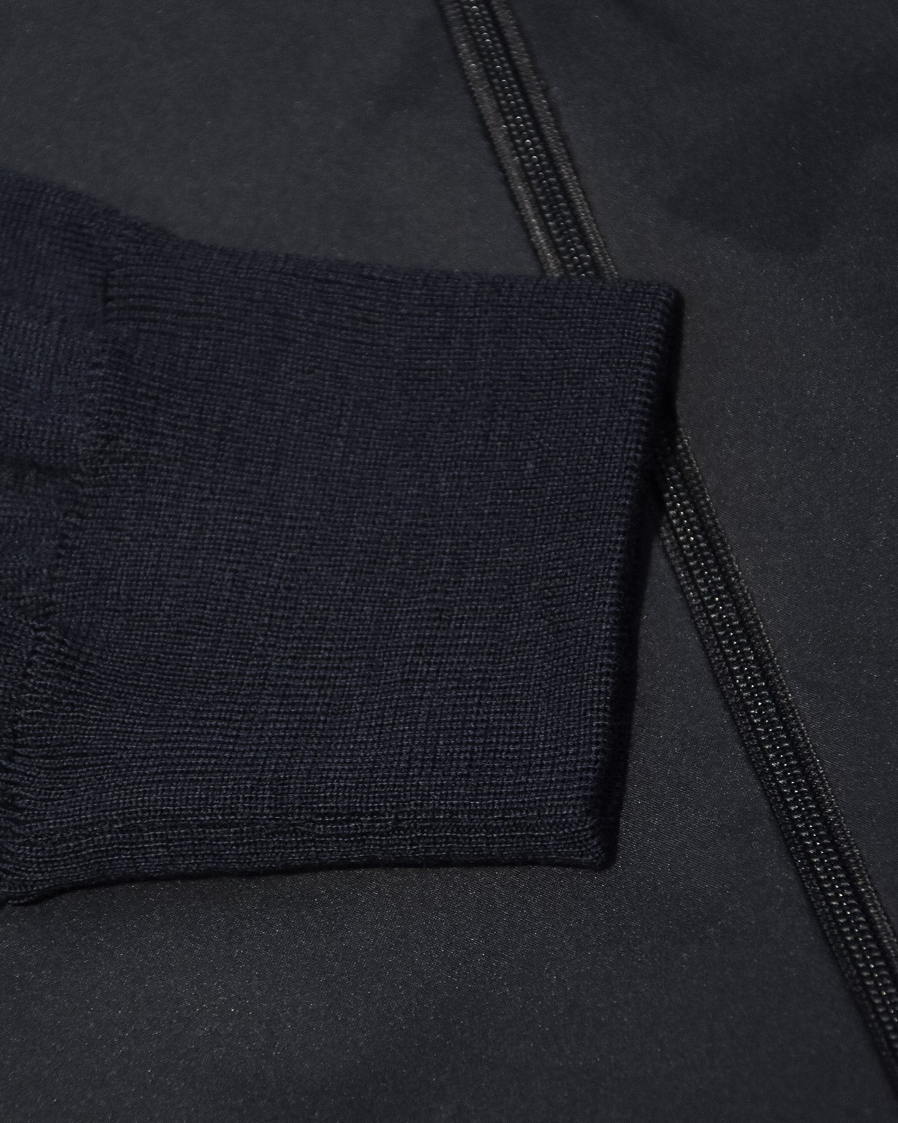 Navy ribbed knit cuff and zipper tape detail