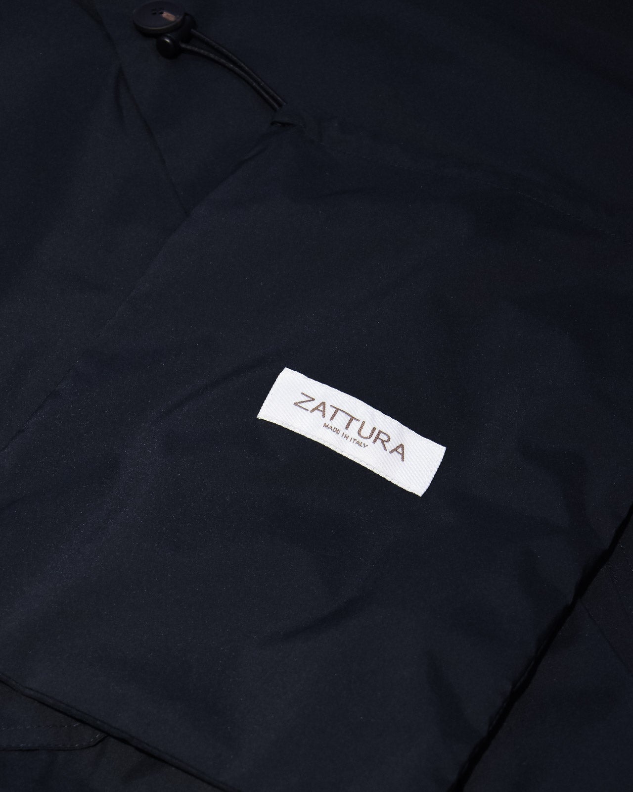 Navy tech bomber jacket with ZATTURA fabric label