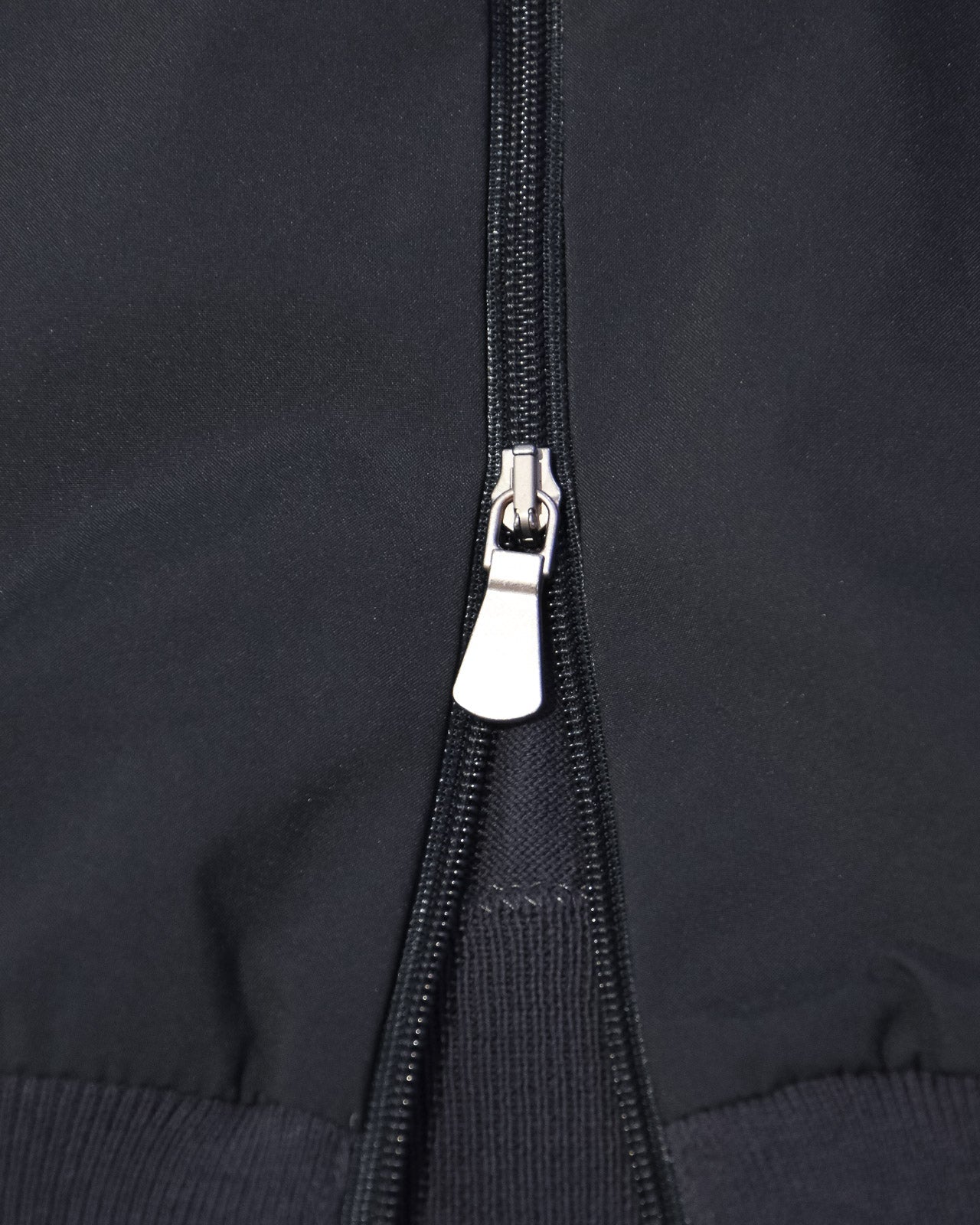 Metal zipper with slider on dark hybrid jacket