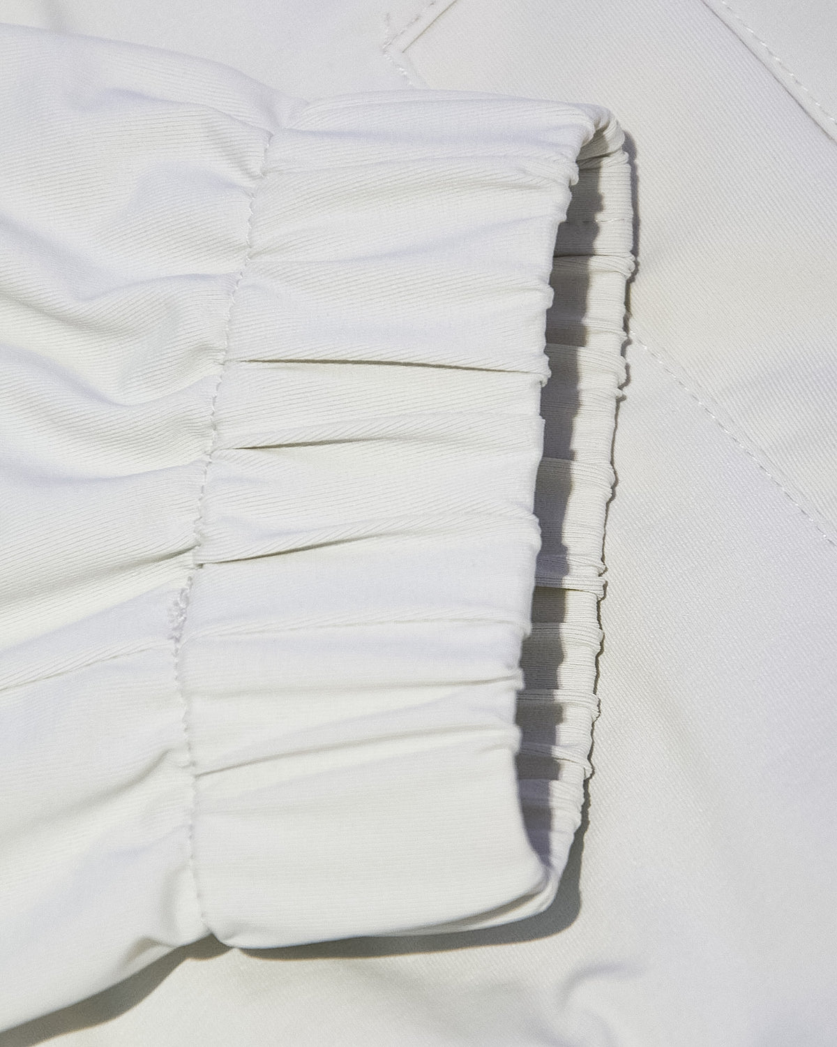 Off-white nylon bomber jacket sleeve cuff and gathered ribbed hem detail
