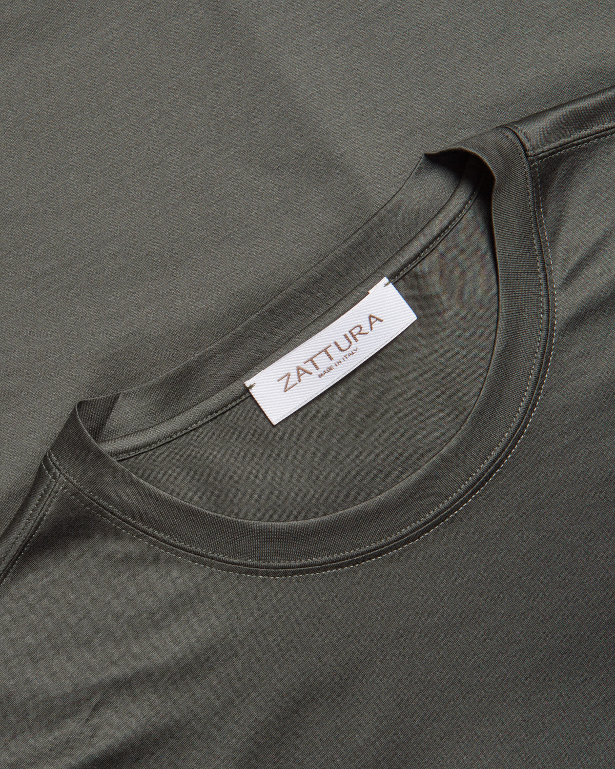 Dark green crew-neck T-shirt with ZATURA neck label