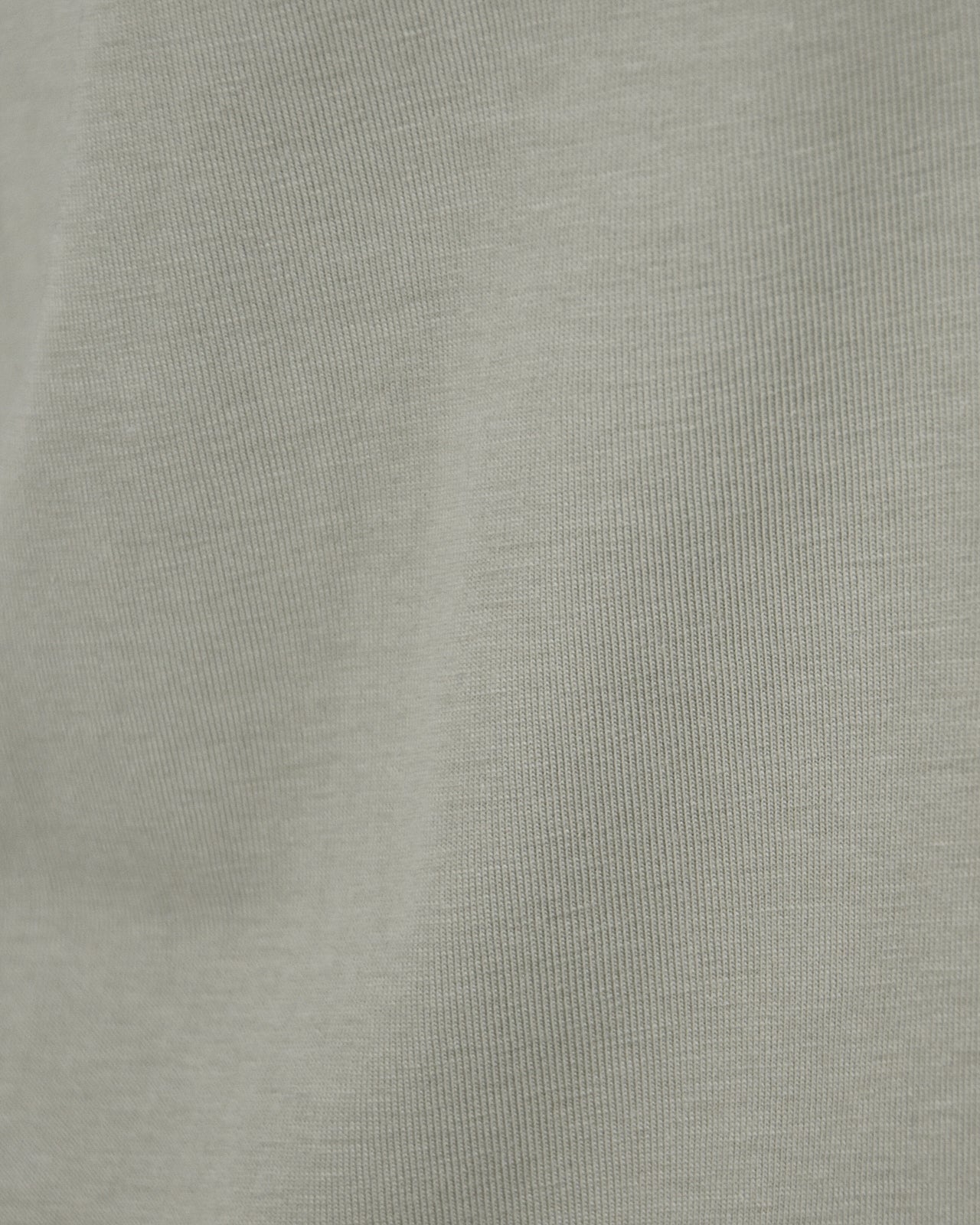 Natural beige knit T-shirt fabric close-up with fine texture