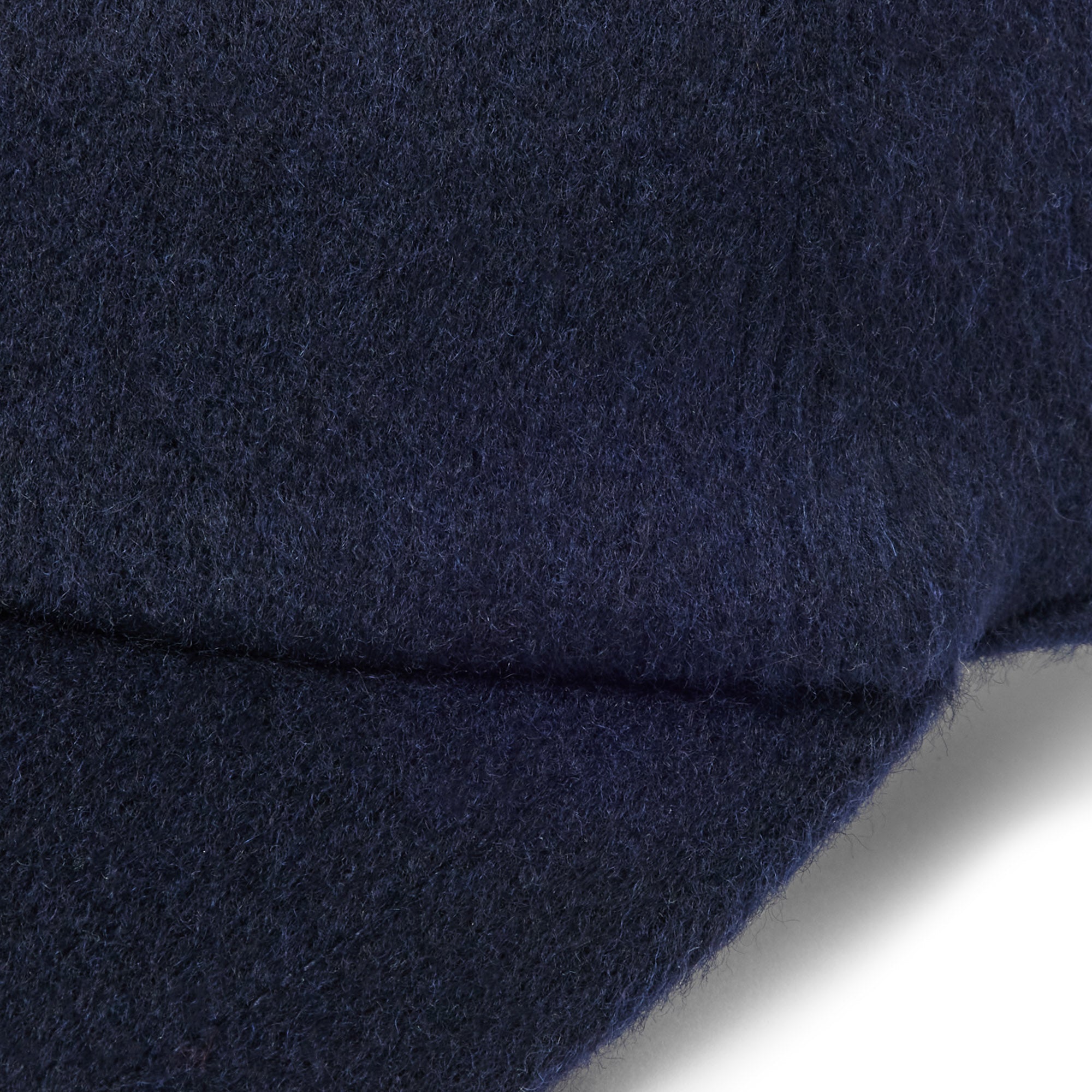 Cashmere-wool cap fabric close-up in midnight navy with elastic brim edge