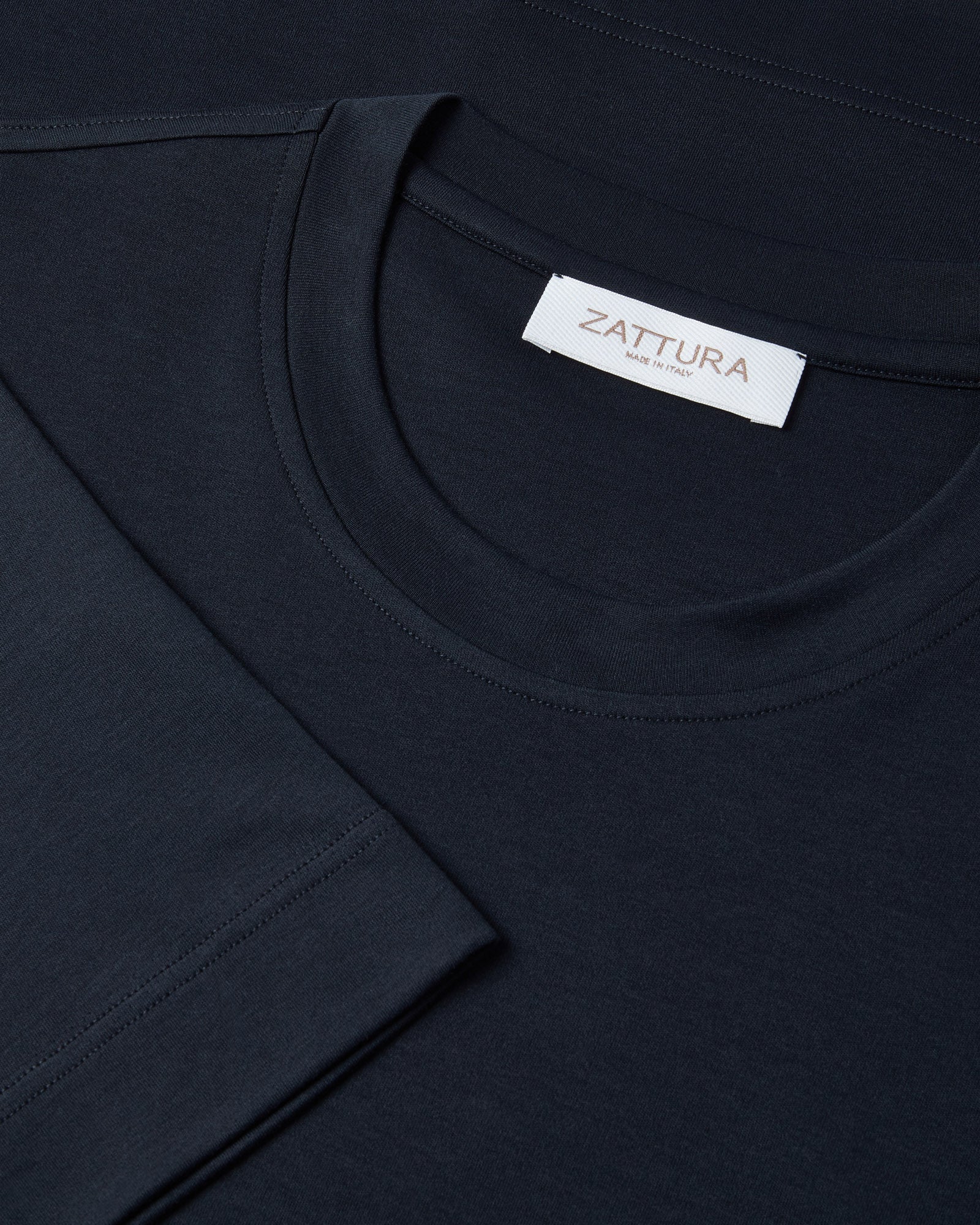 Men's dark navy T-shirt neckline with white ZATtura brand label