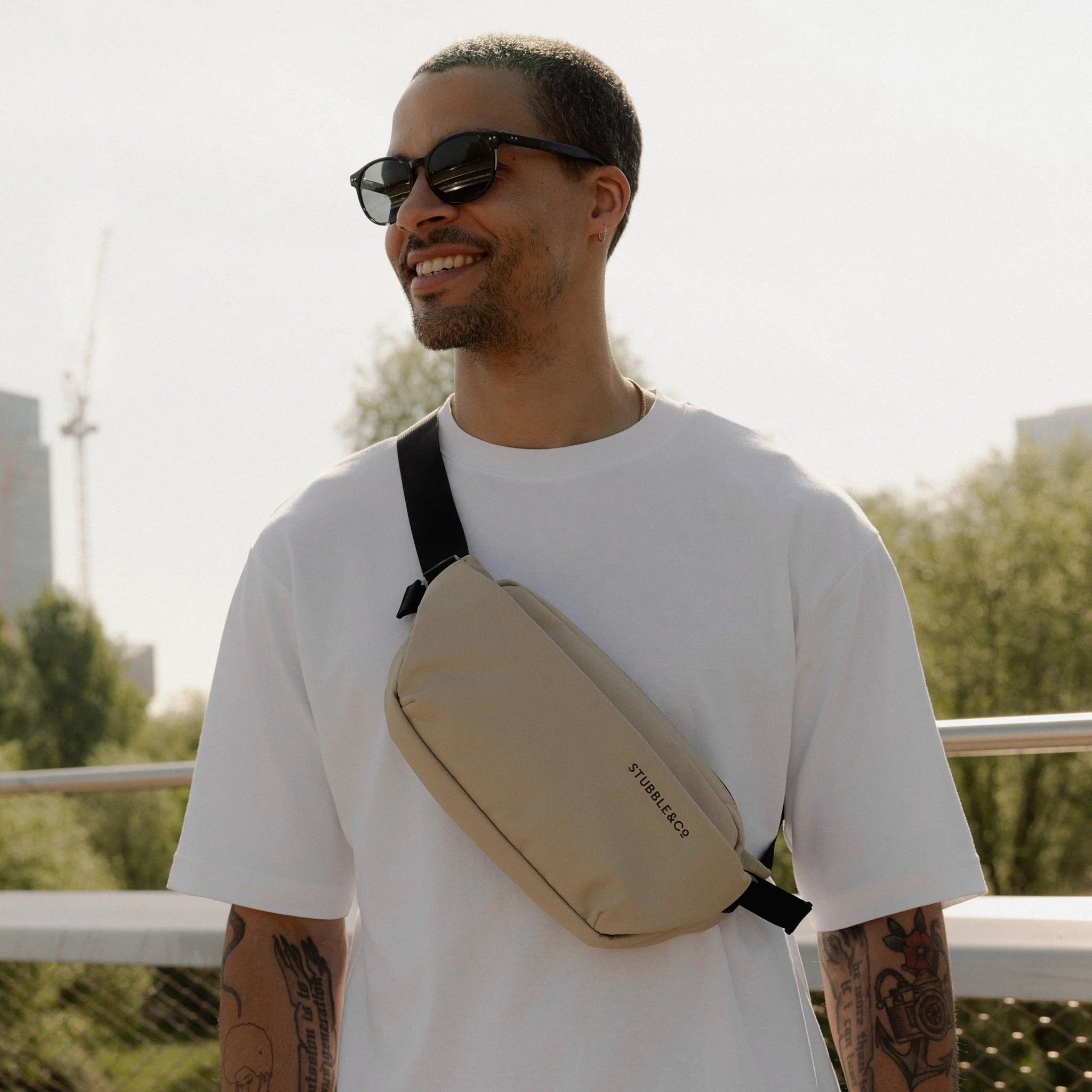 Stubble & Co waterproof crossbody bag in sand worn cross-body with black strap