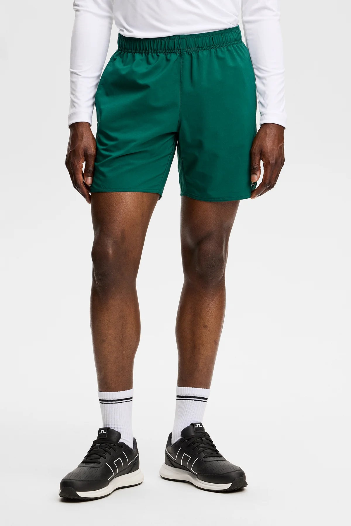 Dark green Preston shorts on model with elastic waistband and small logo detail