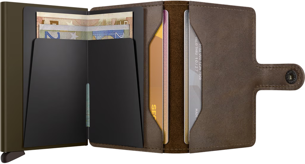 Secrid mini wallet with multiple cards visible inside and snap closure on brown leather.