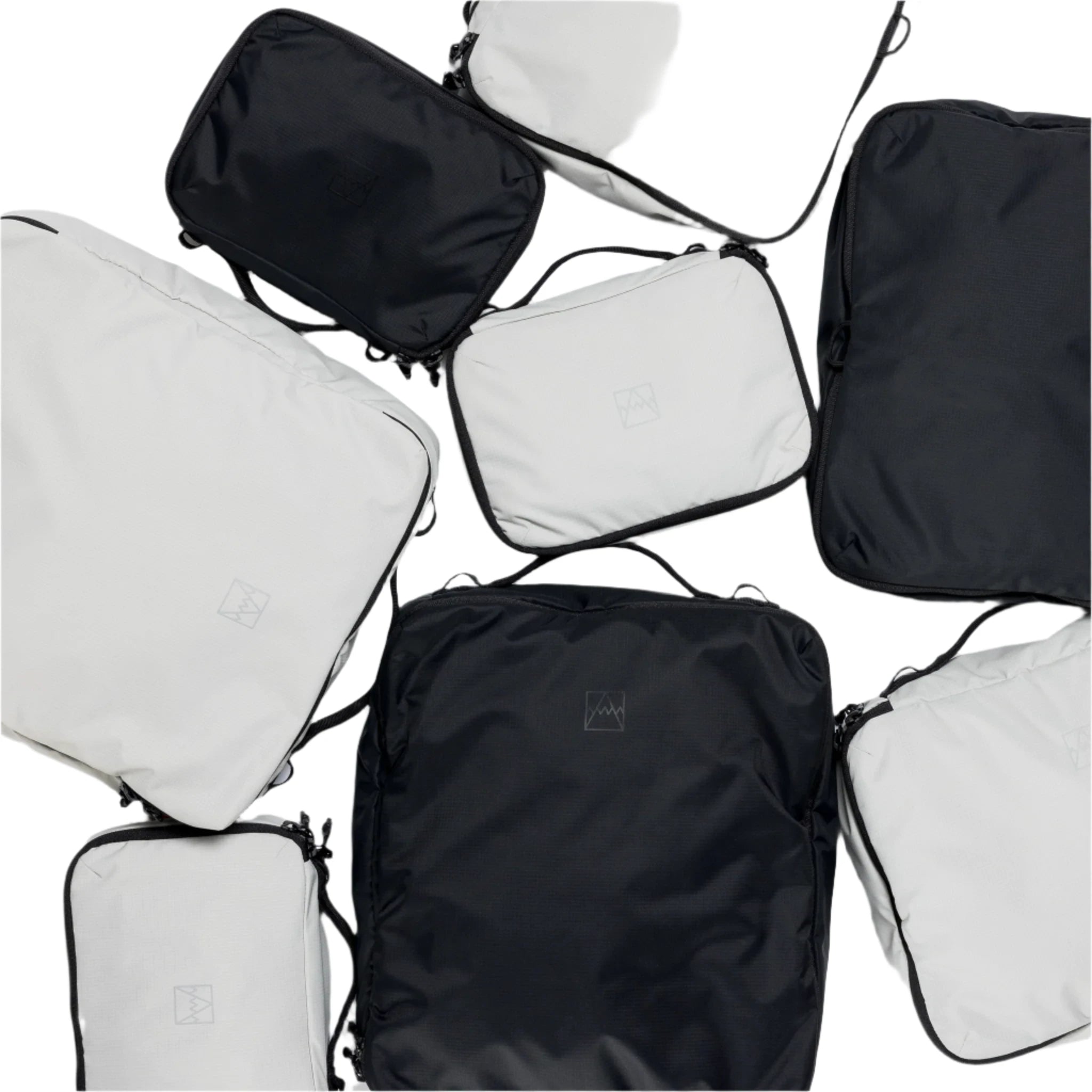 Black packing cube with handle and zipper, shown with other color cubes
